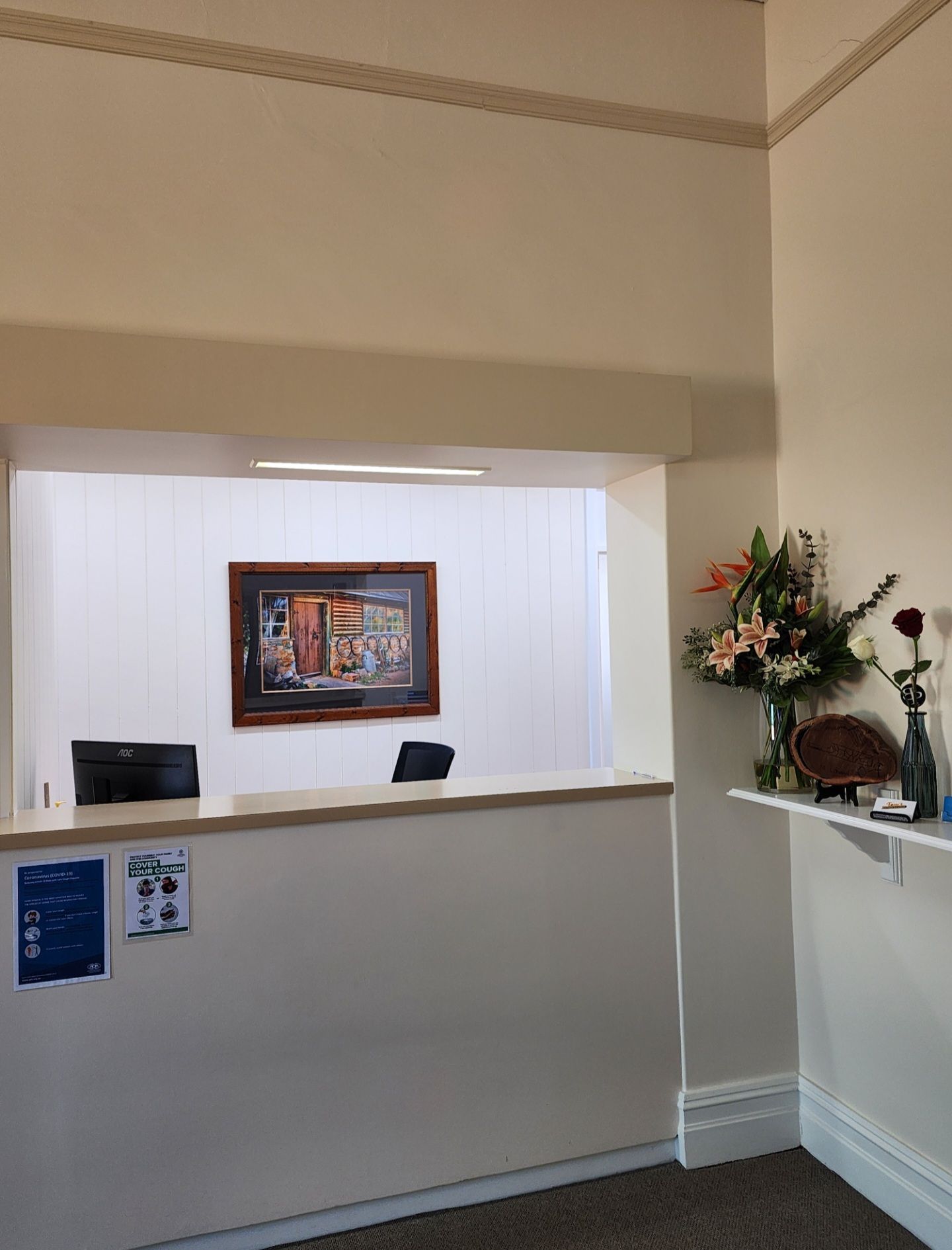 A woman is giving a thumbs up in a dental chair