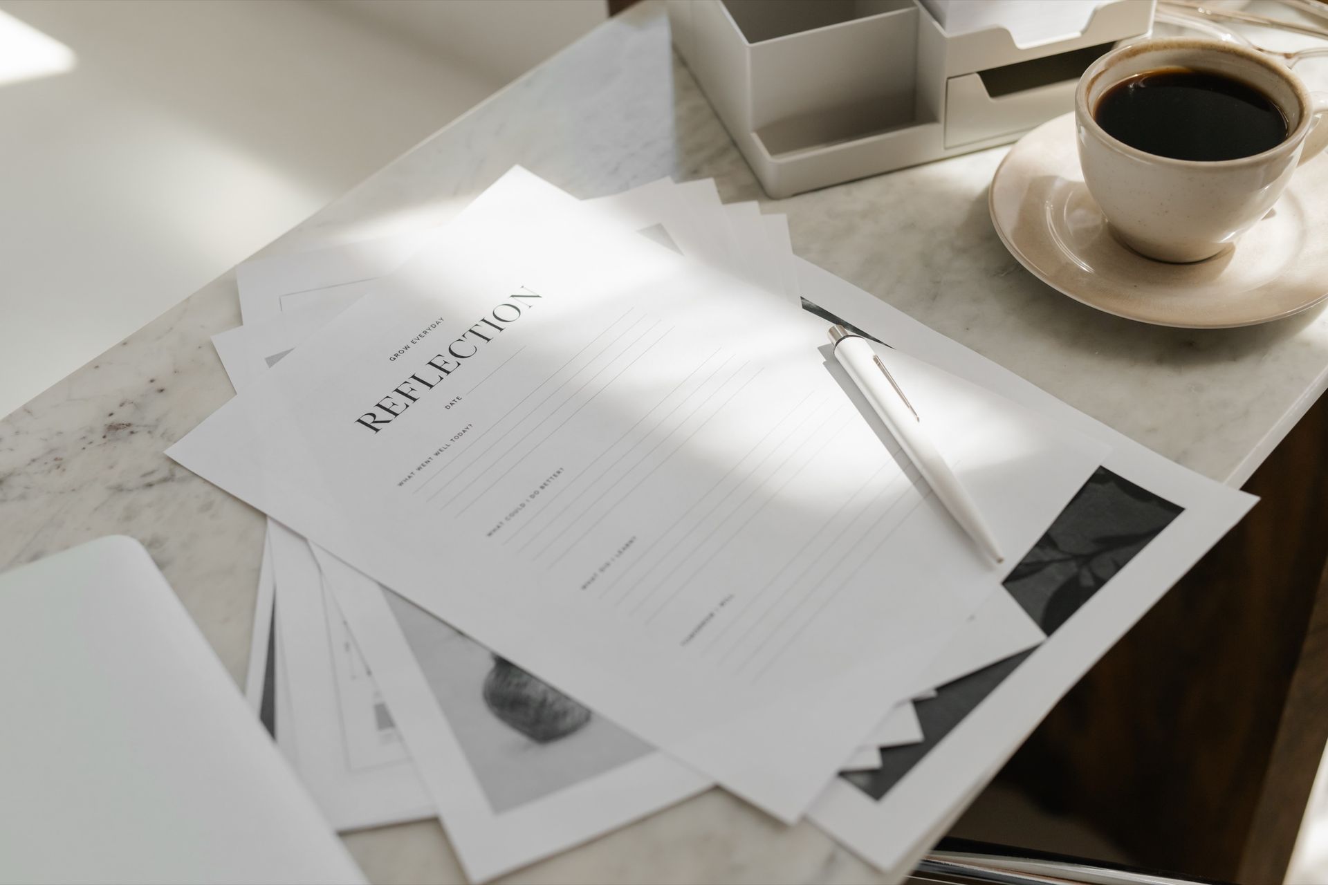 Paperwork and coffee on a desk, representing real estate contract review.