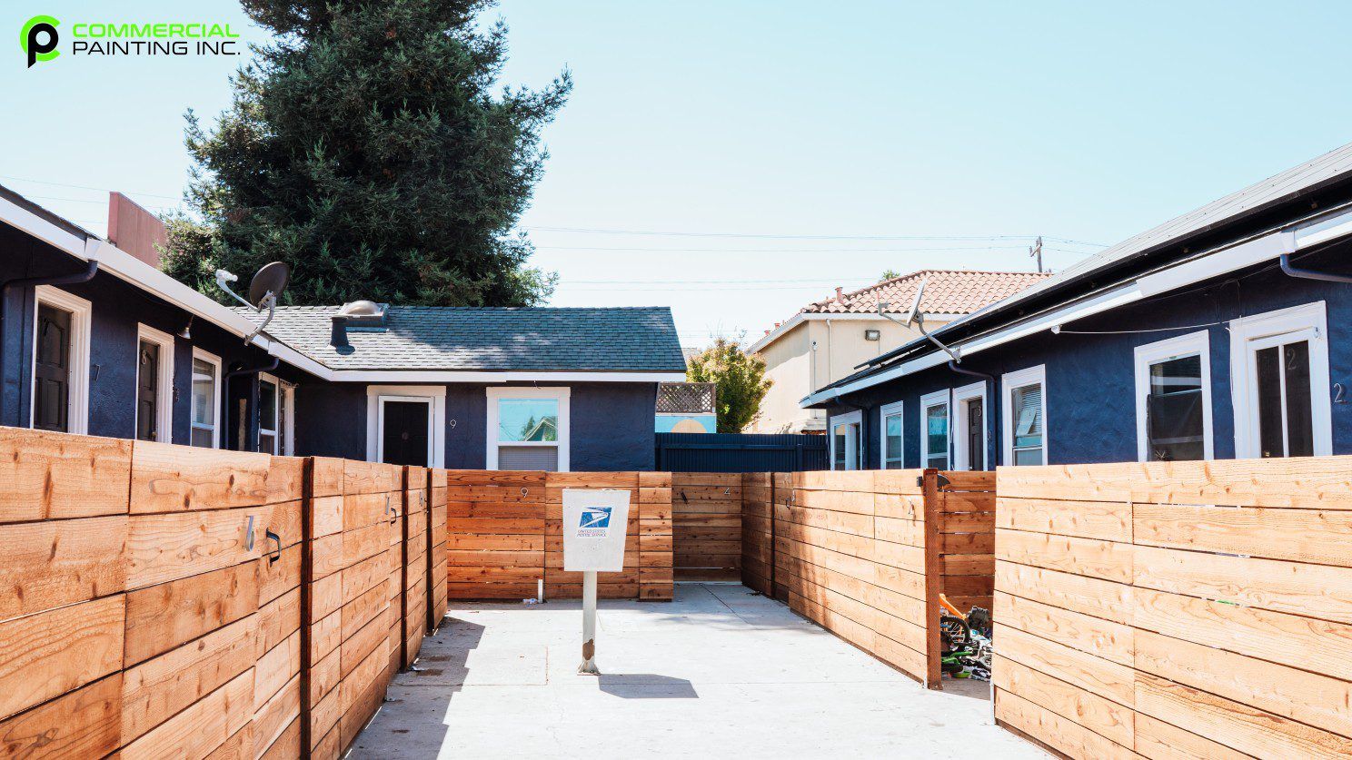 A row of houses with a wooden fence between them