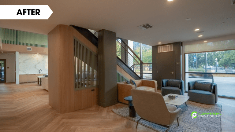 A living room with chairs , a table and a staircase.