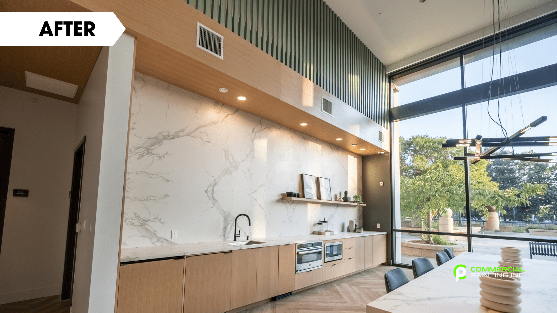 A kitchen with a long table and a large window.