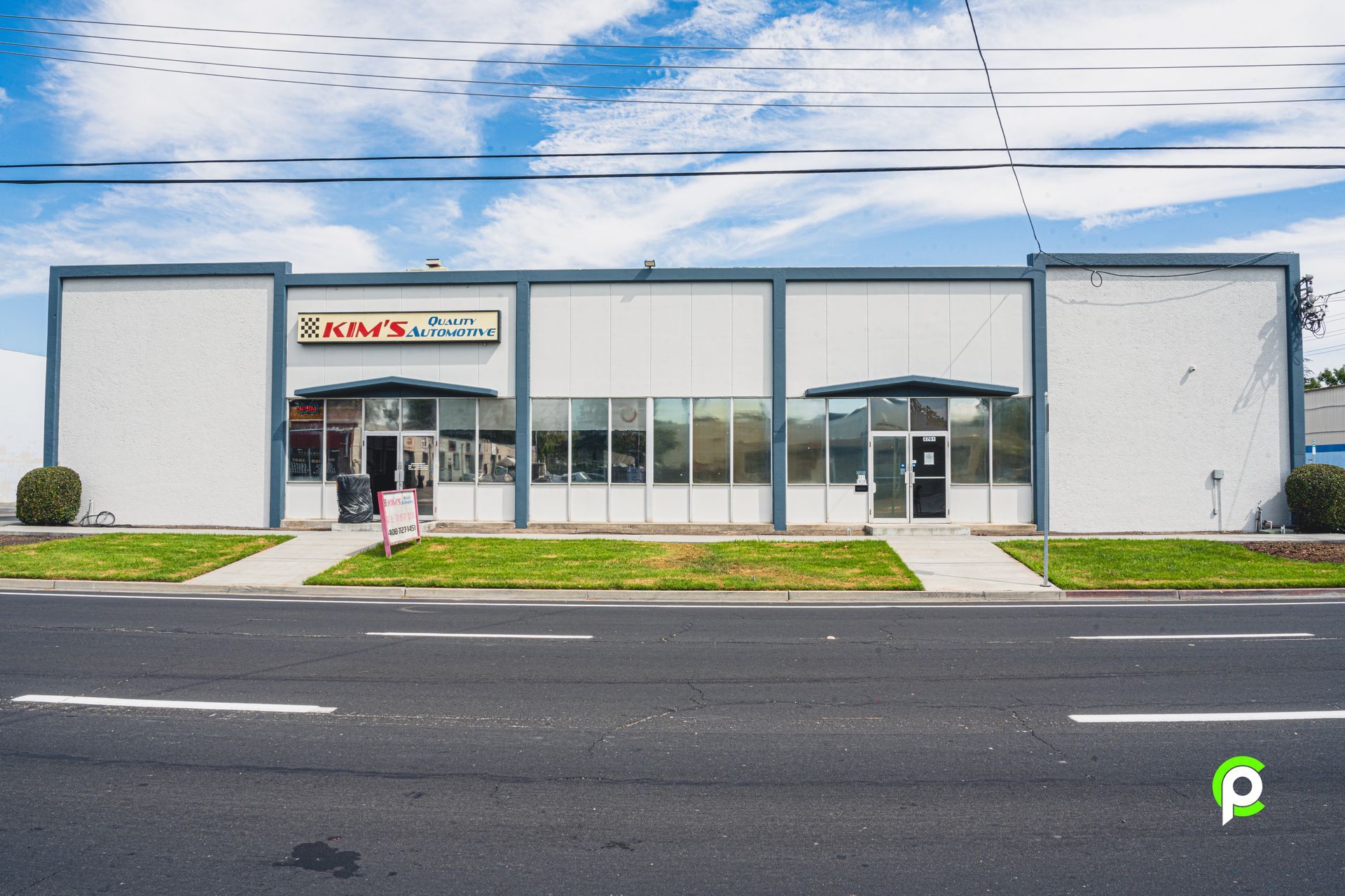 White building with gray trim and large windows; 