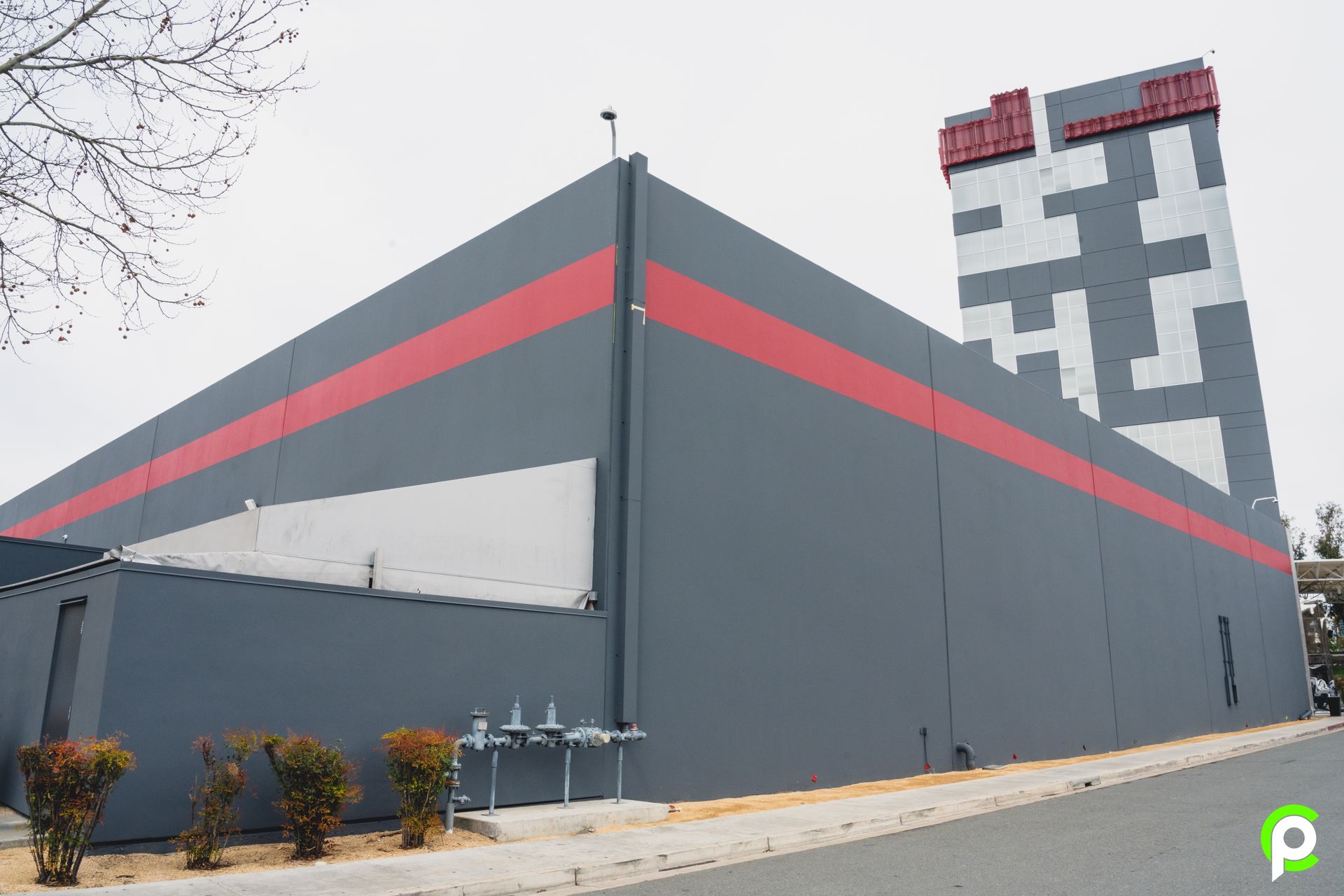 A large building with a red and white stripe on the side