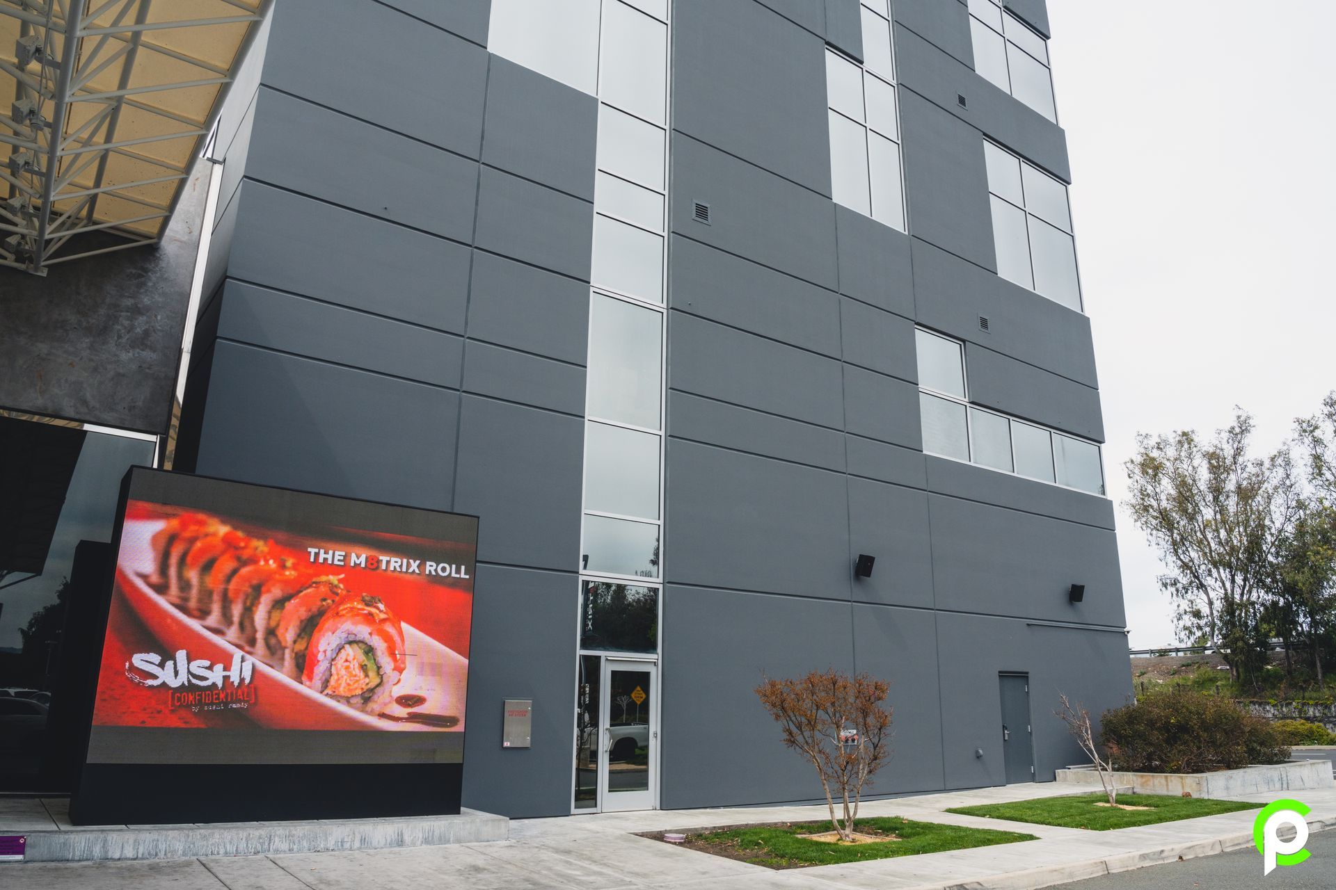 A large building with a sign that says sushi on it