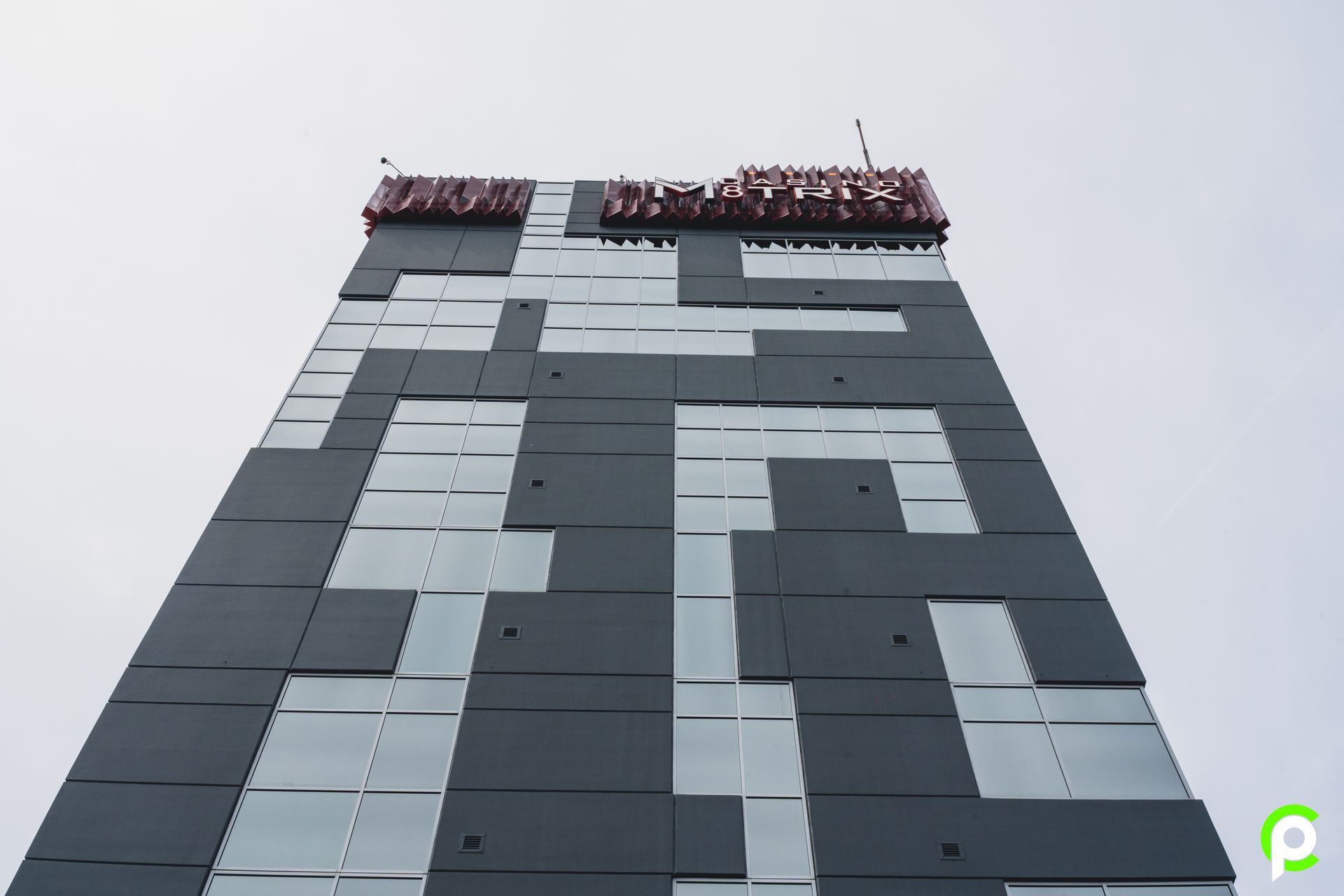 Looking up at a building with the letter p on it