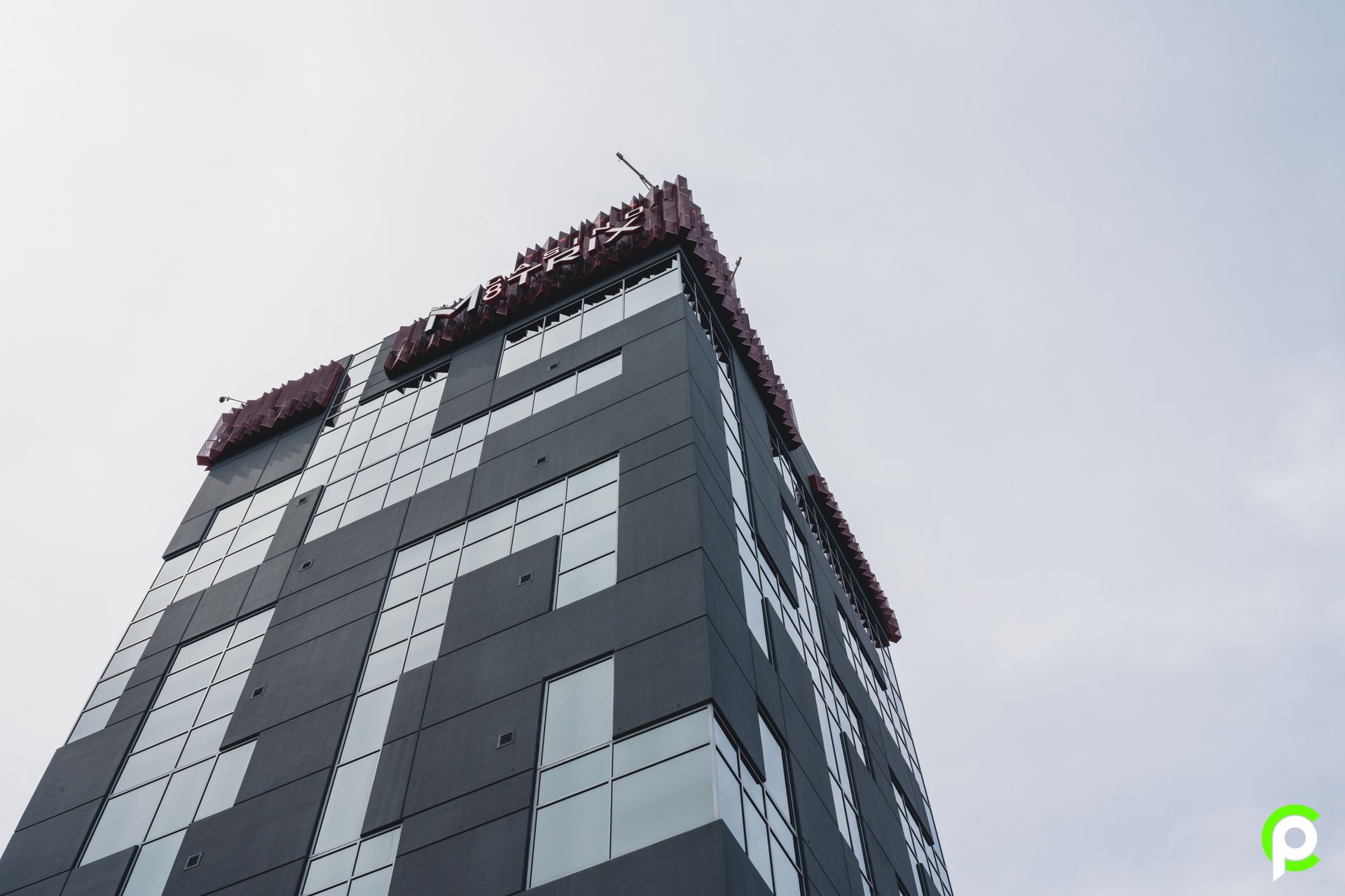 Looking up at a tall building with the letter p on it