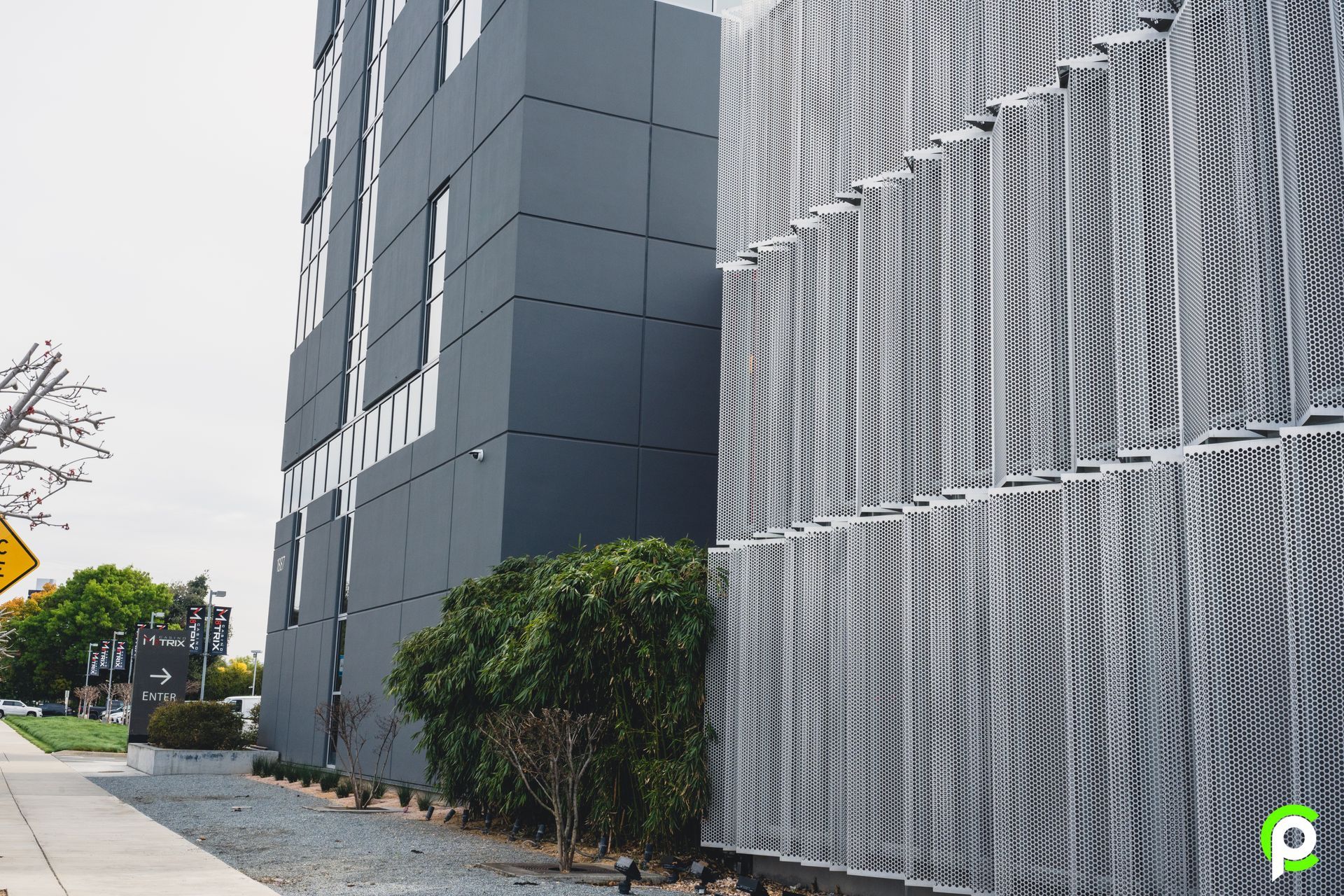 A large building with a metal fence in front of it