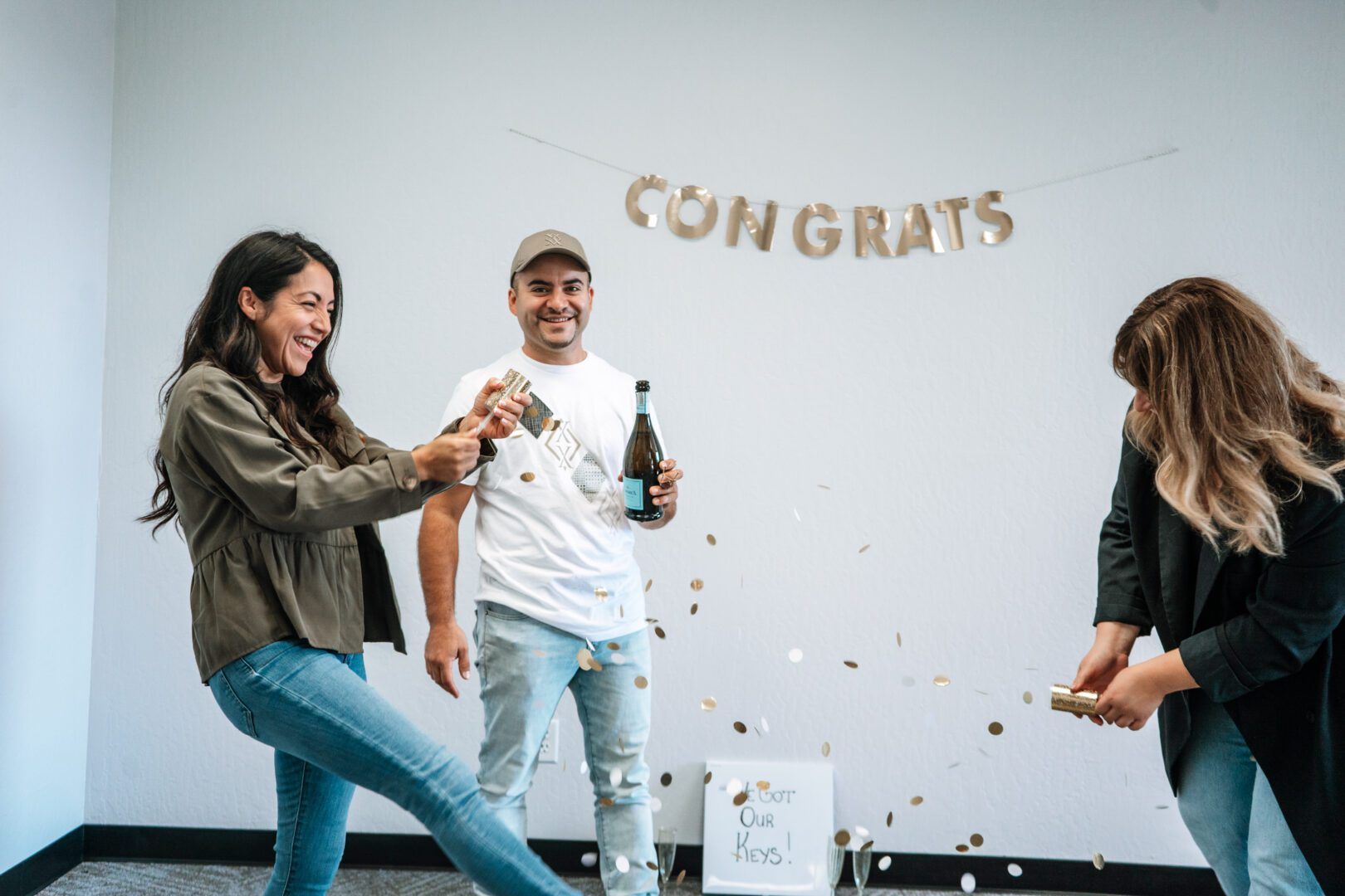 A group of people are celebrating with champagne and confetti.