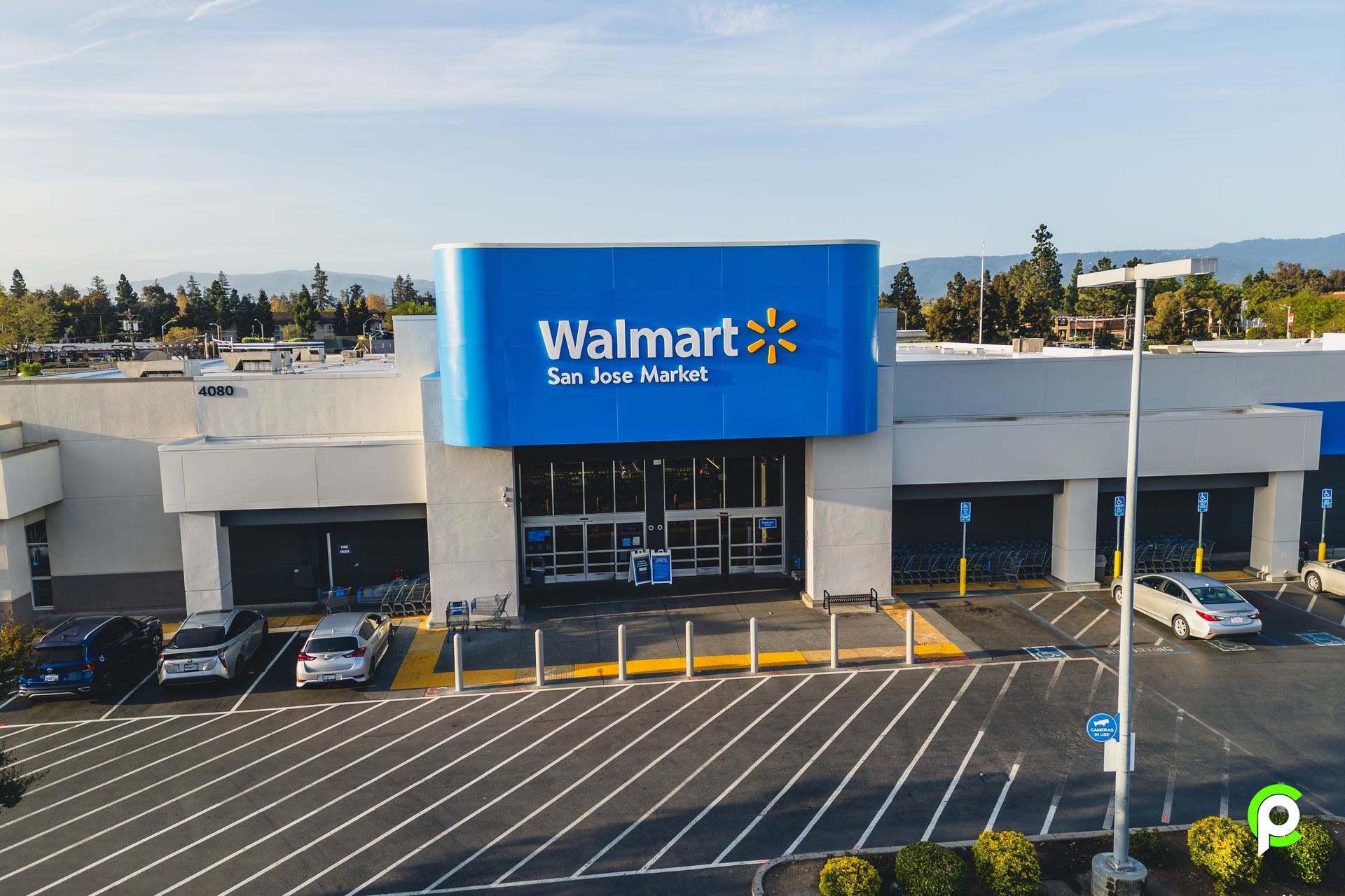An aerial view of a walmart store with cars parked in front of it