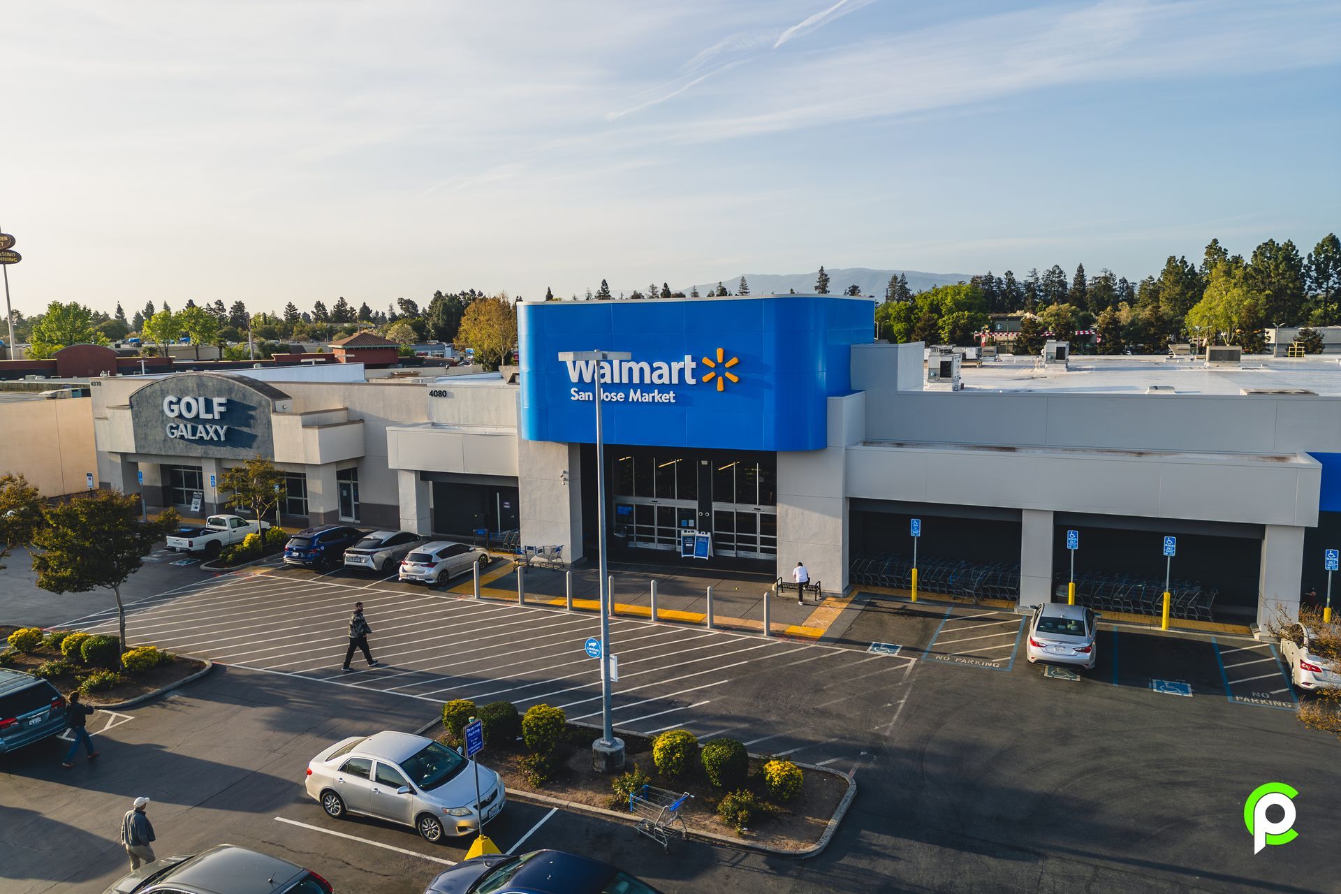 An aerial view of a walmart store with cars parked in front of it.