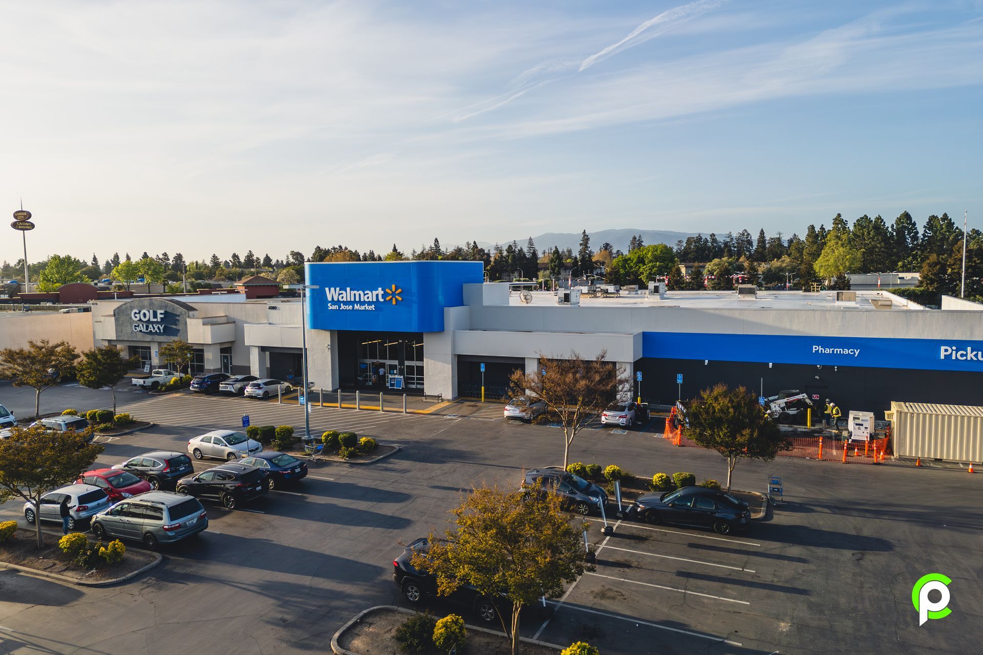 An aerial view of a walmart store with cars parked in front of it.