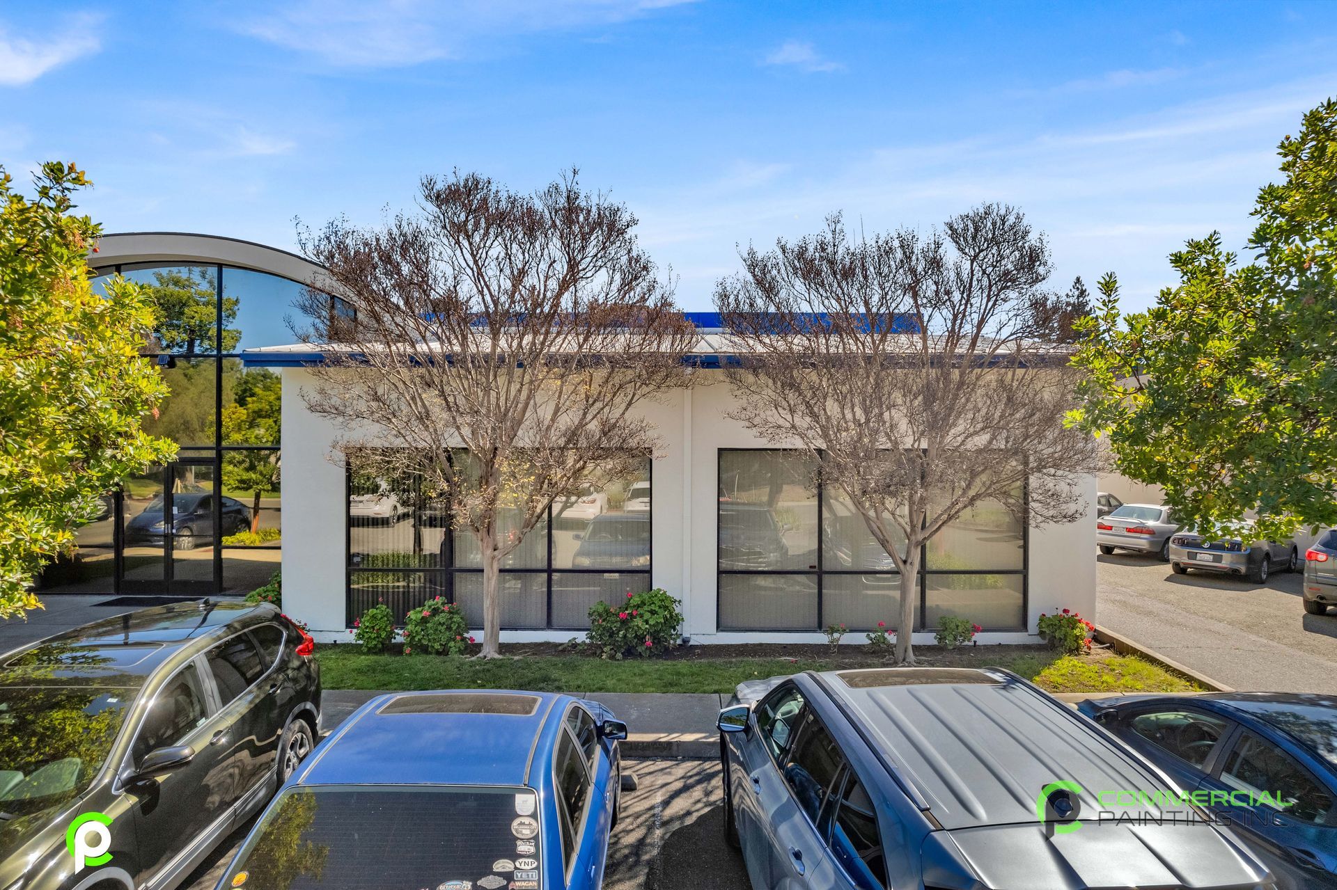 A building with a lot of cars parked in front of it.
