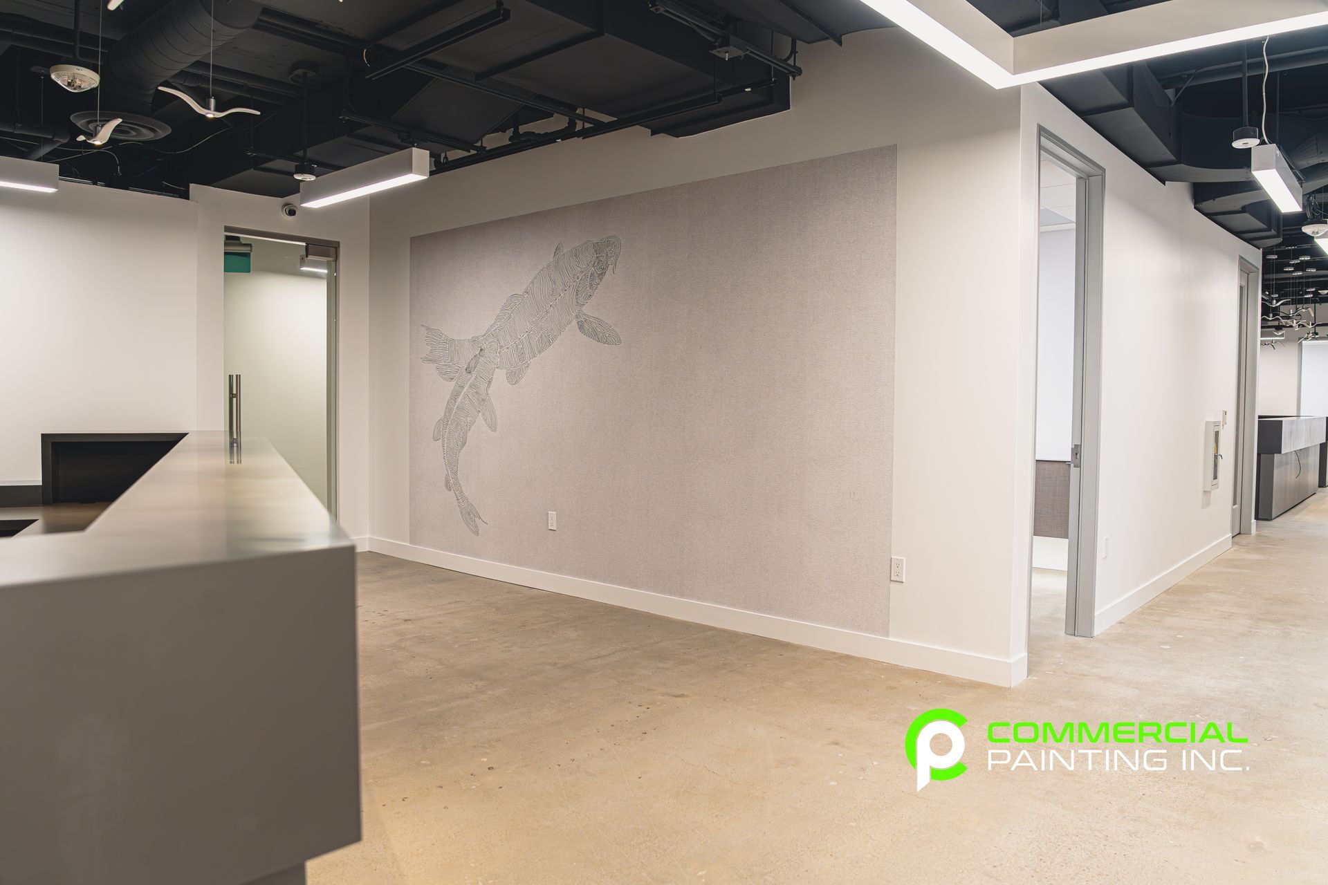 There is a large painting on the wall in the middle of the room.