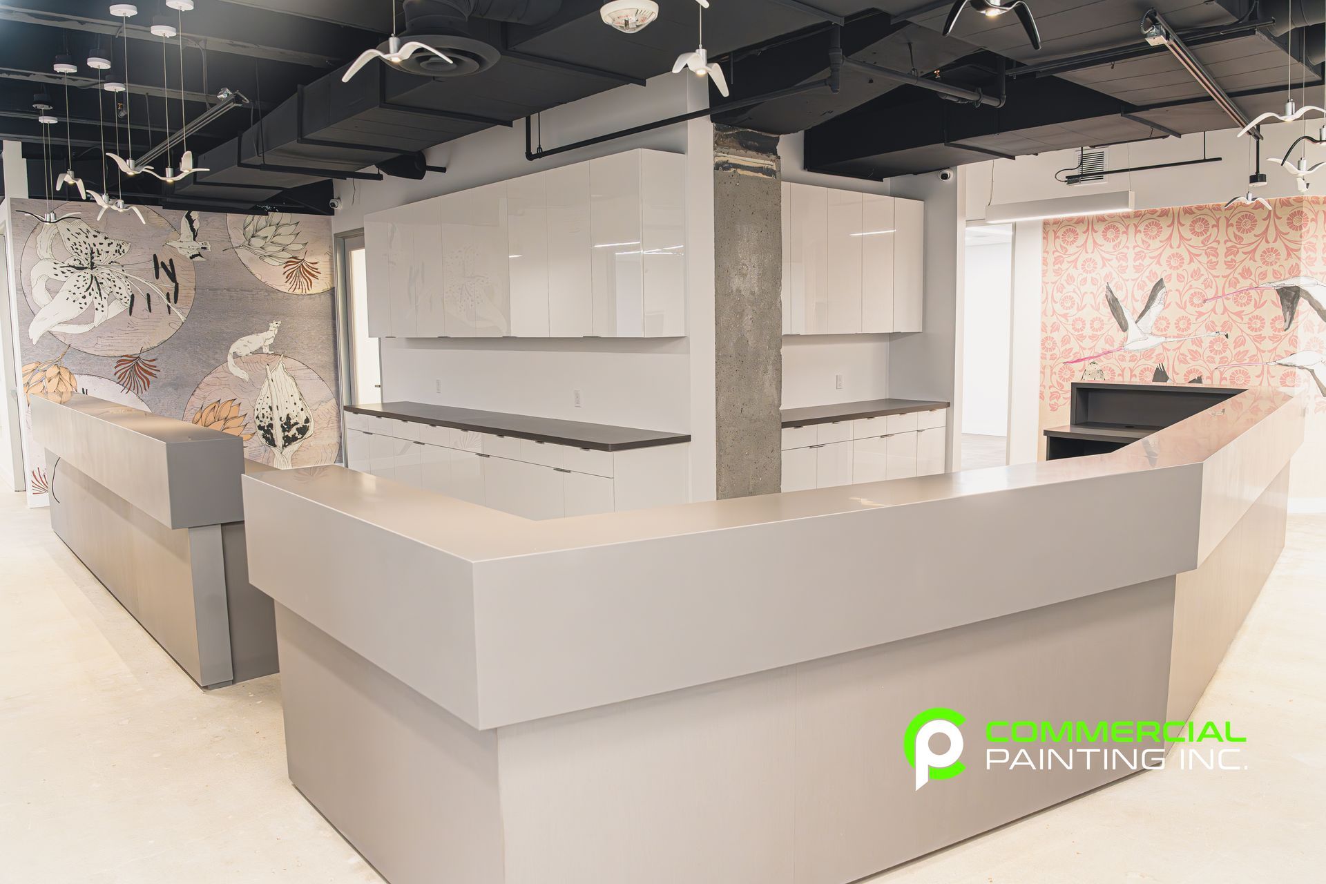 A reception area in a building with white counter tops and cabinets.