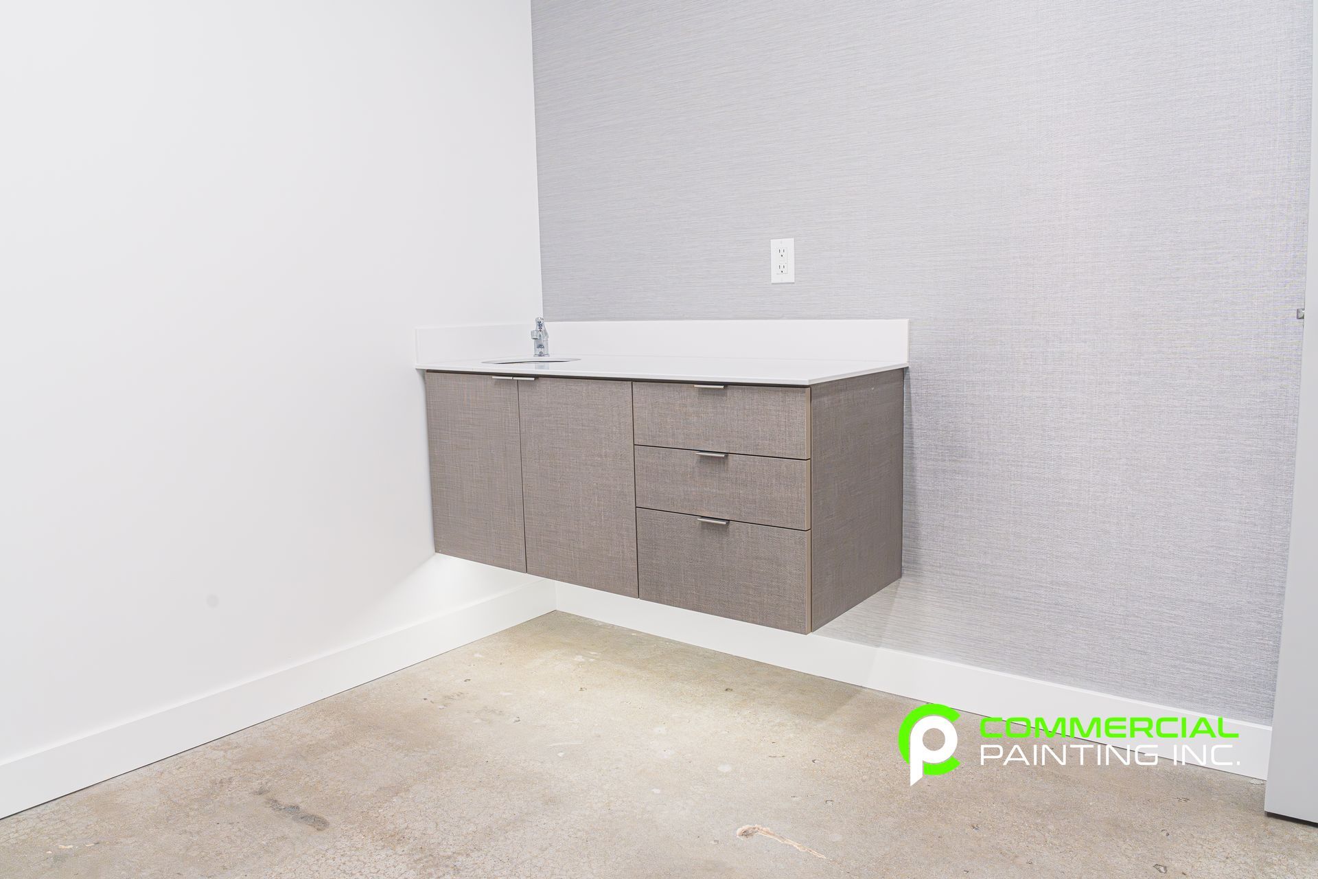 An empty room with a floating cabinet on the wall.