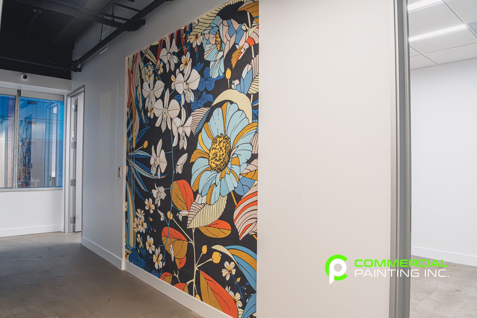 A hallway with a large floral mural on the wall.