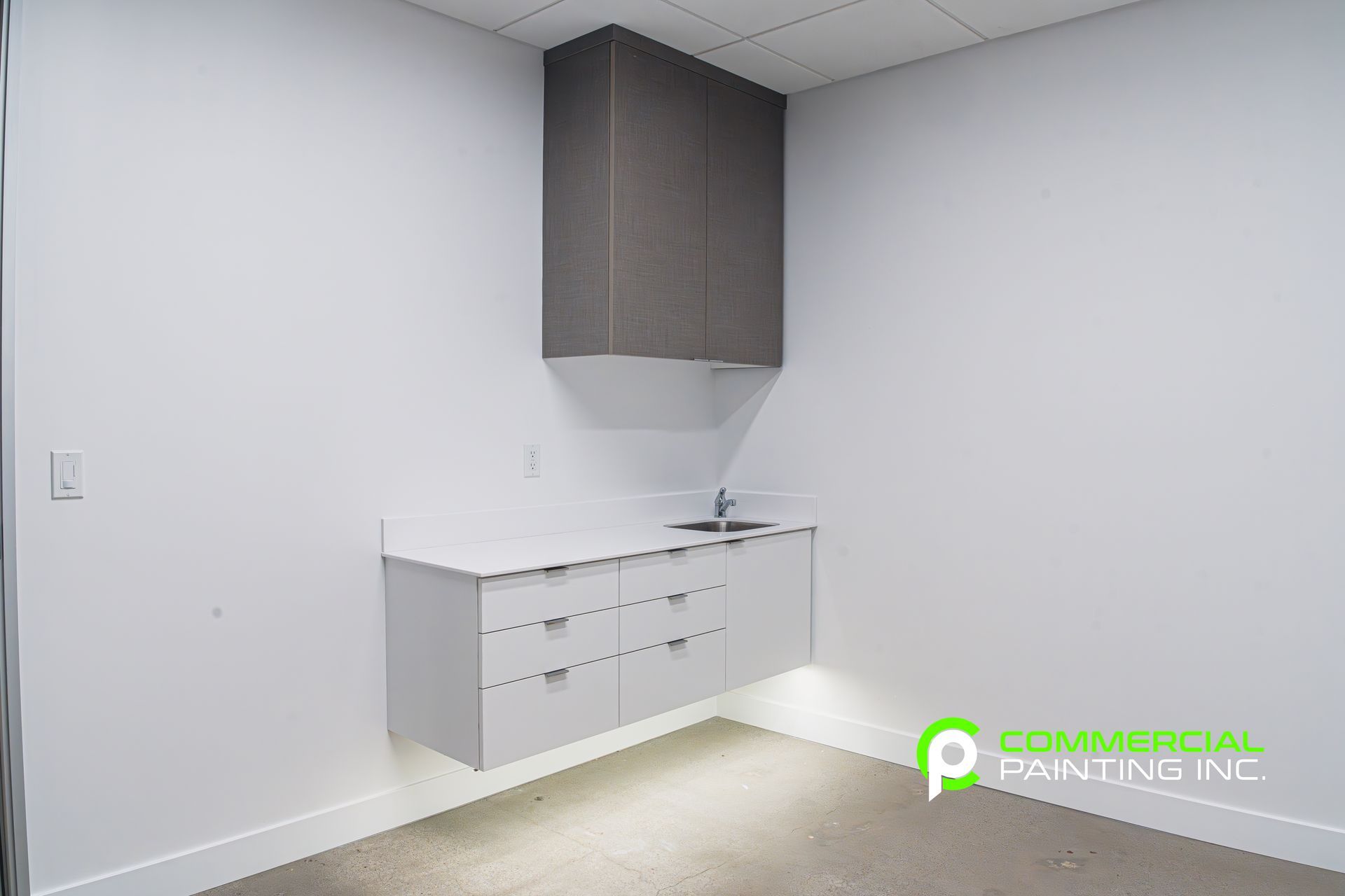 There is a sink in the corner of the room.