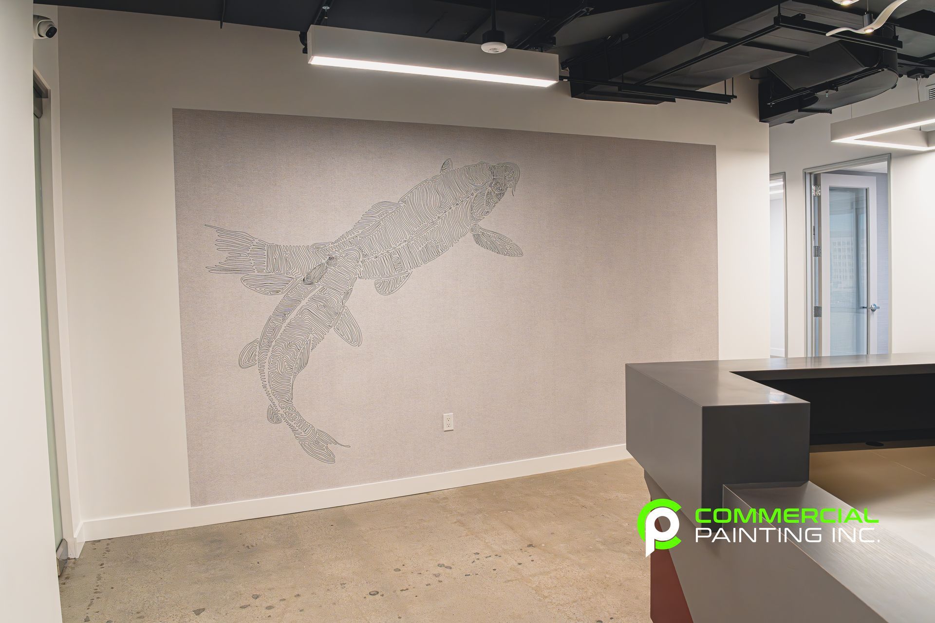 An empty room with a painting of a fish on the wall.