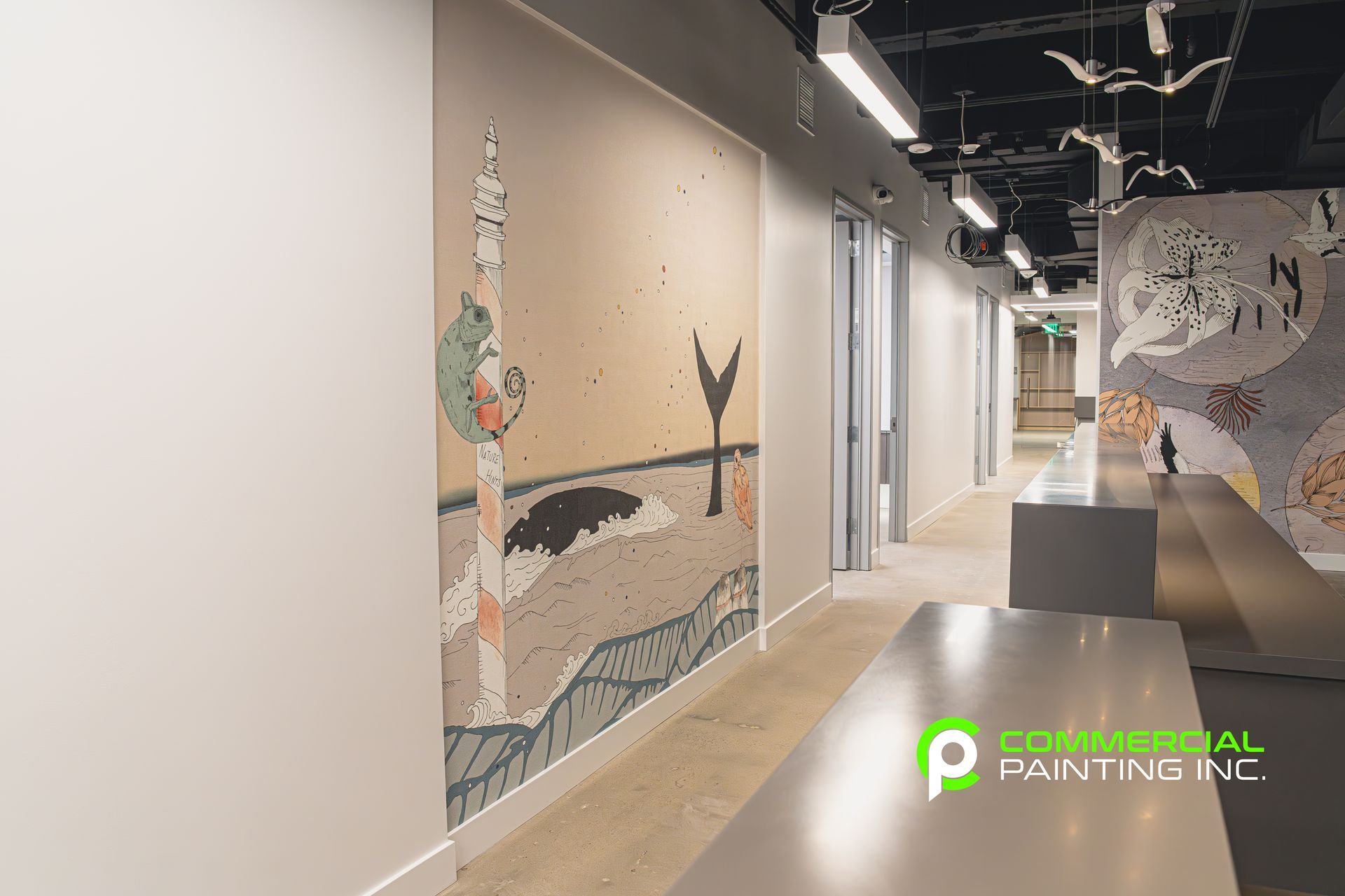 A hallway with a painting on the wall and a table.