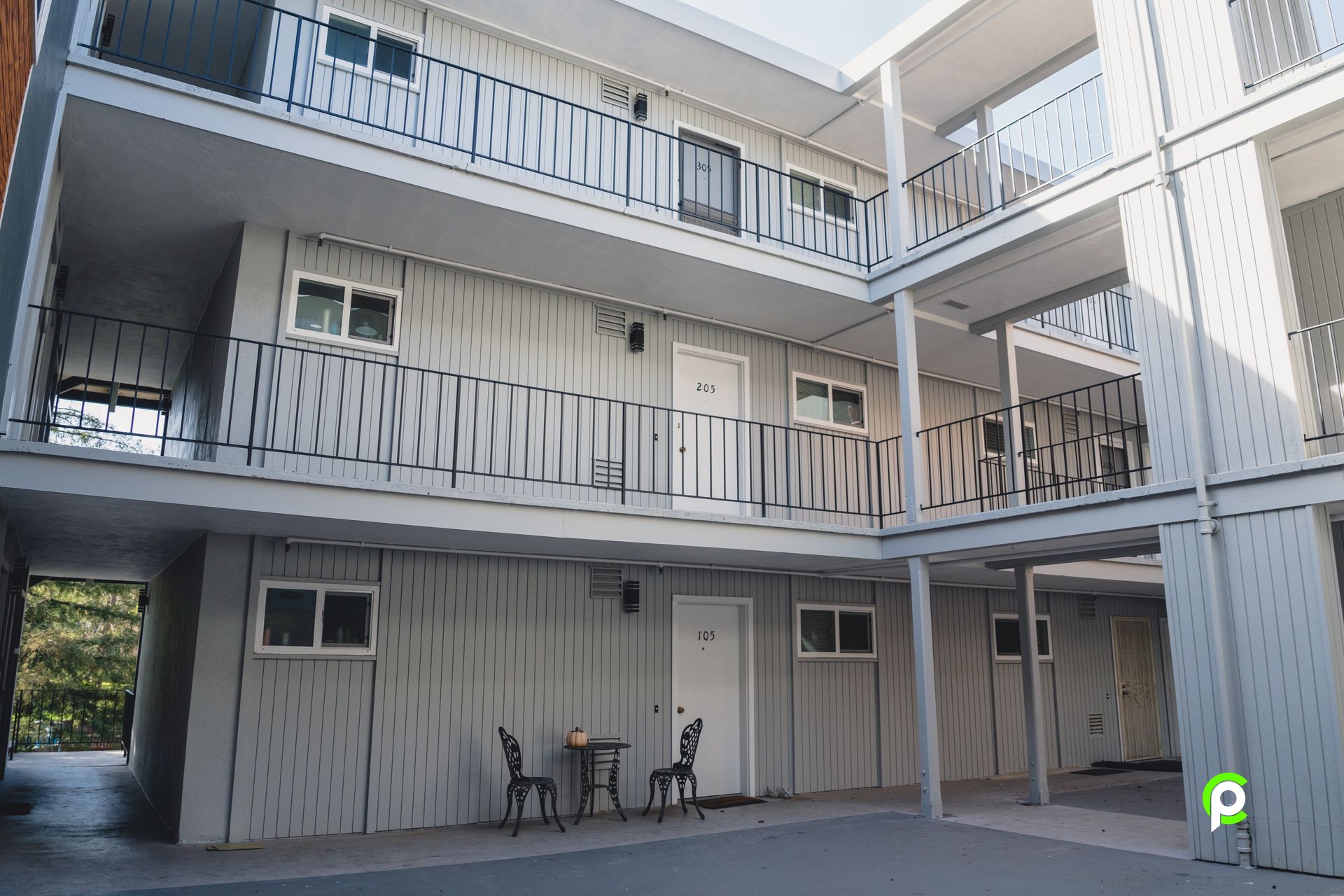 There is a table and chairs in the middle of the building.