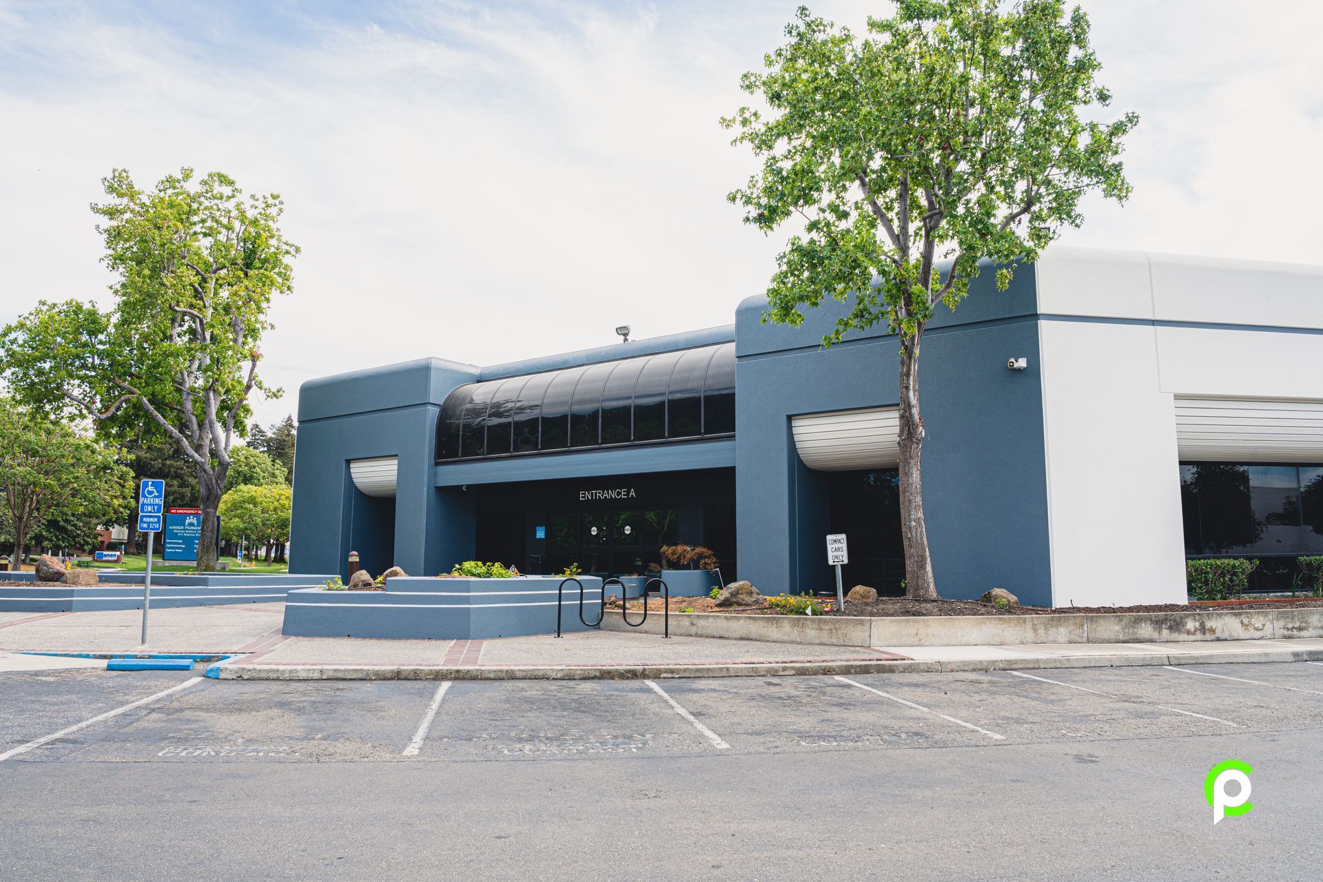 A large building with a parking lot in front of it