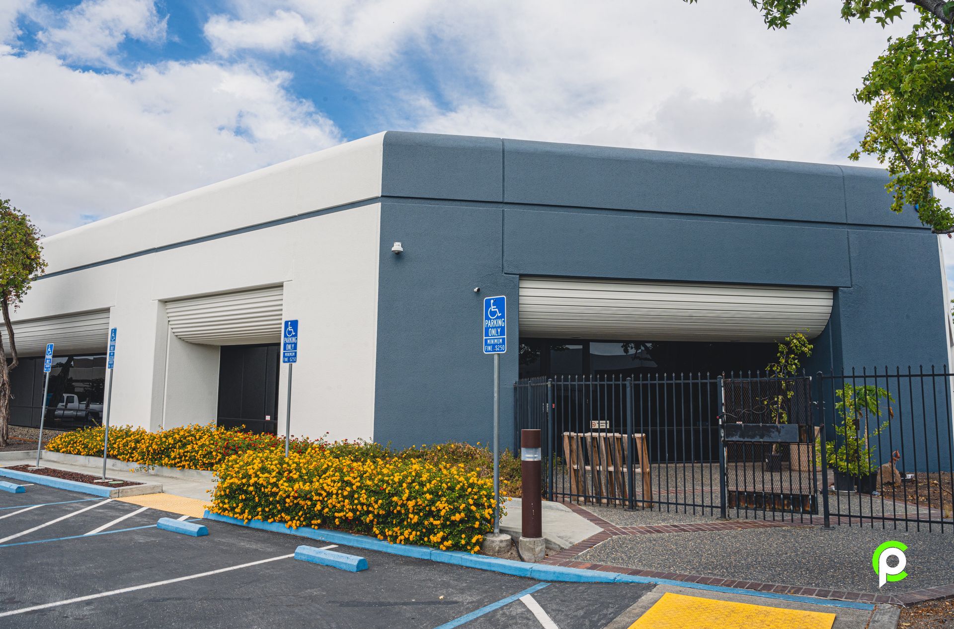 A large building with a handicapped parking spot in front of it