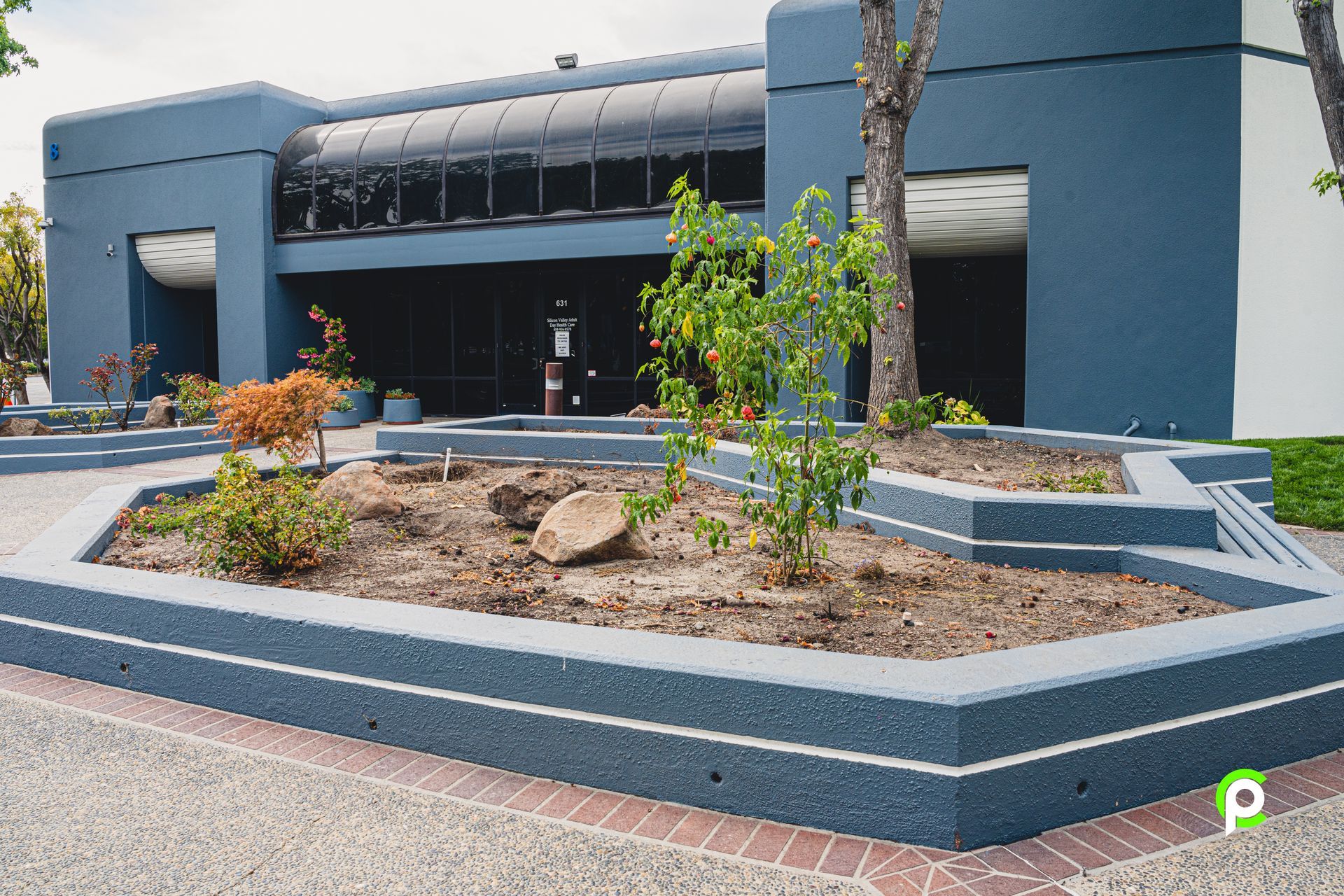 A blue building with a brick walkway in front of it