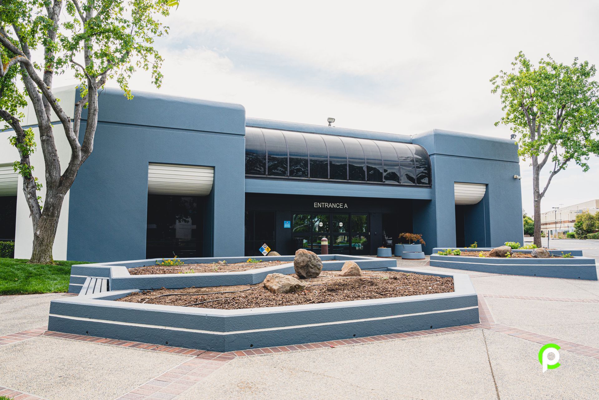 A large building with a few trees in front of it