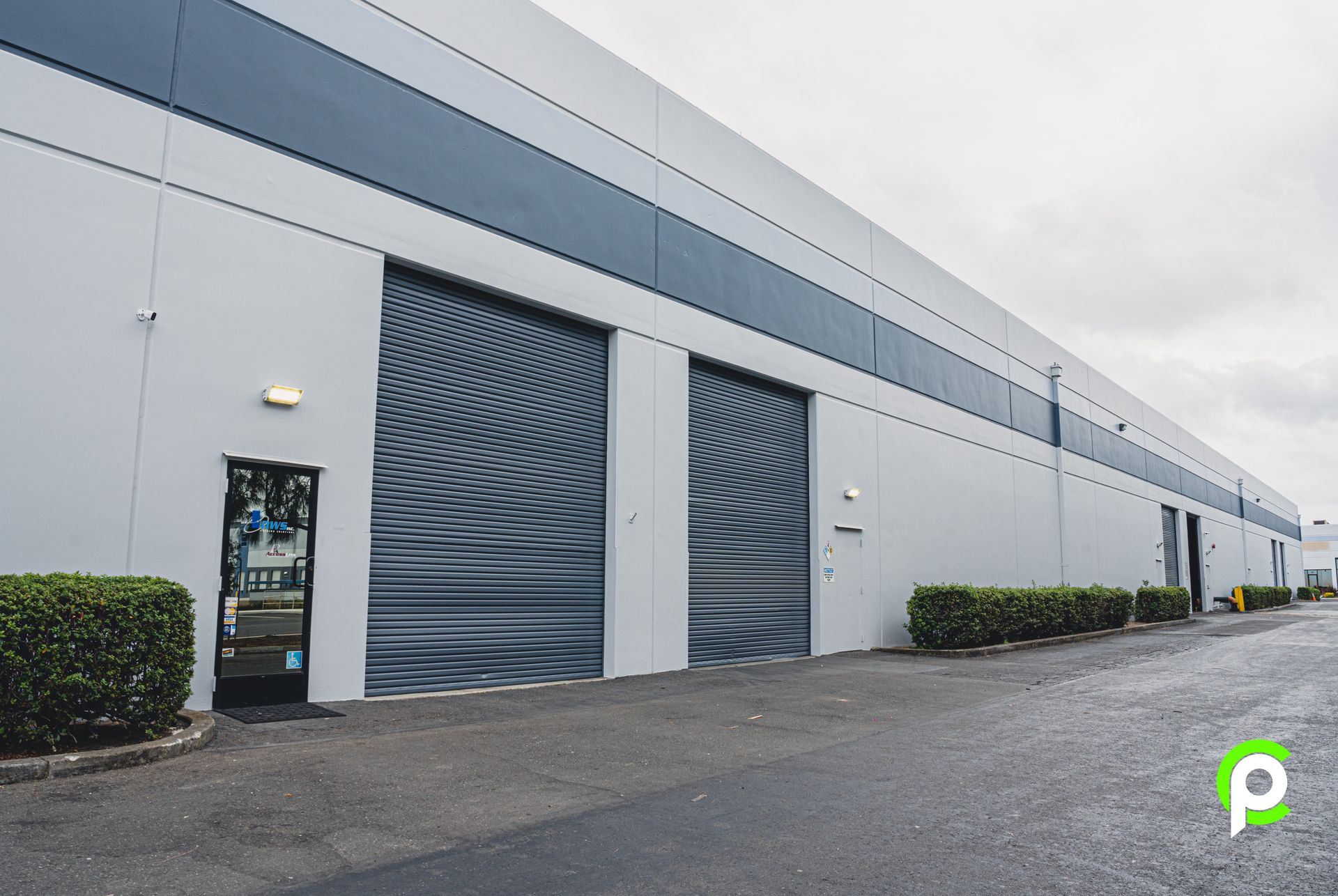 A large building with a lot of doors and a sign that says ' p ' on it