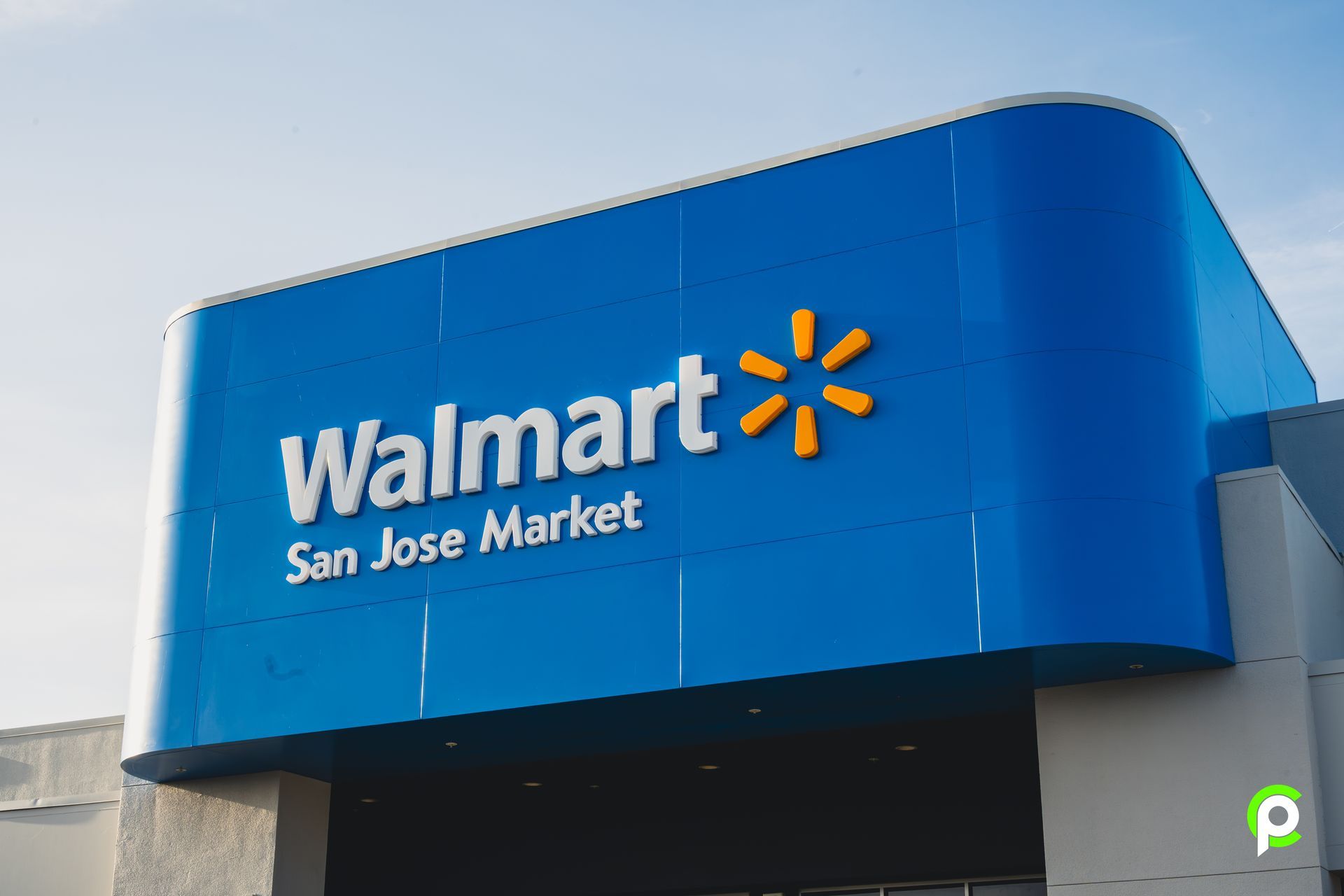 A walmart store in san jose market with a blue sign