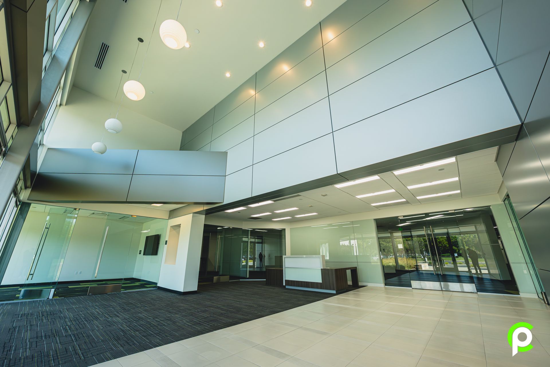 A large empty lobby with a green p on the bottom right