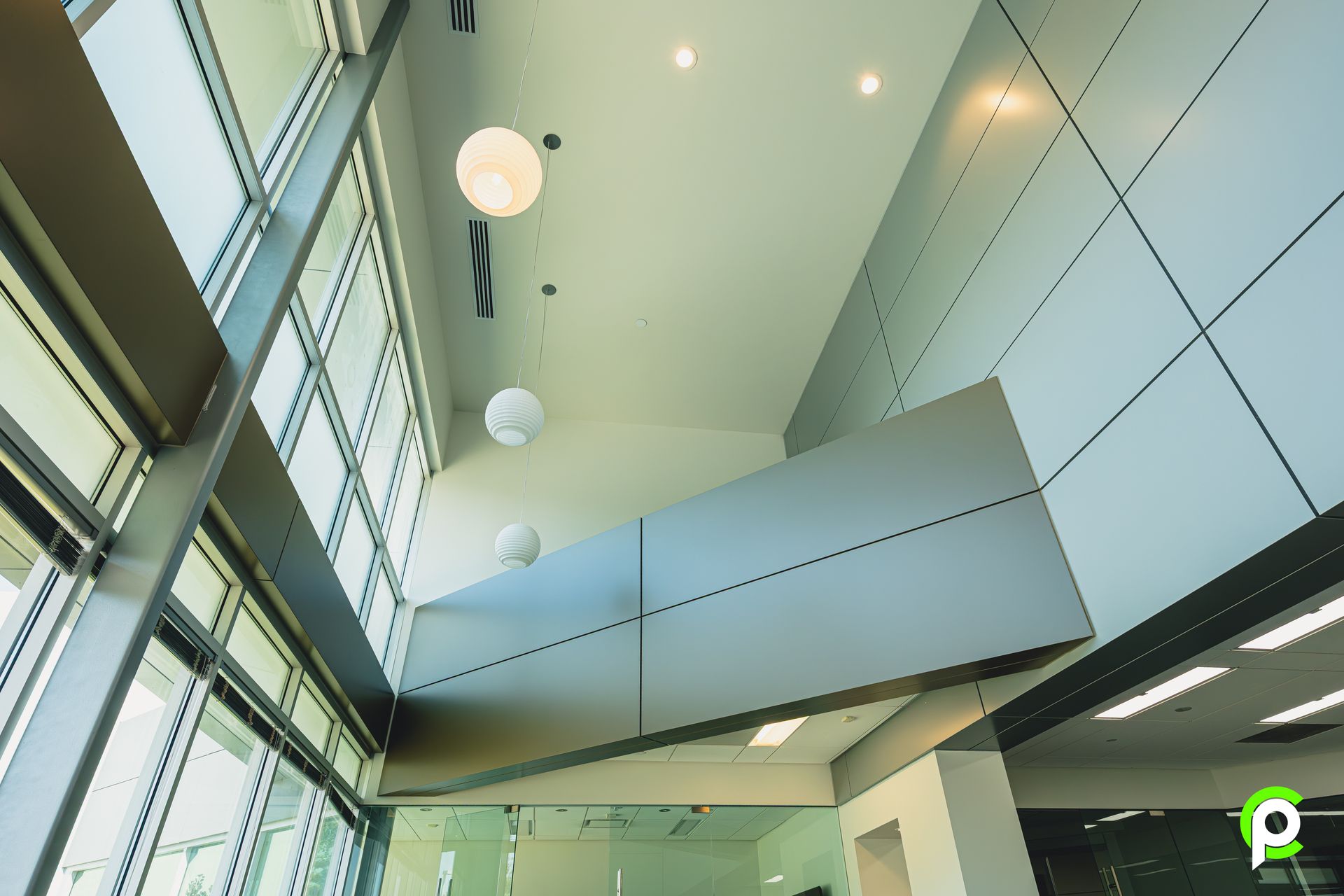 Looking up at the ceiling of a building with lots of windows