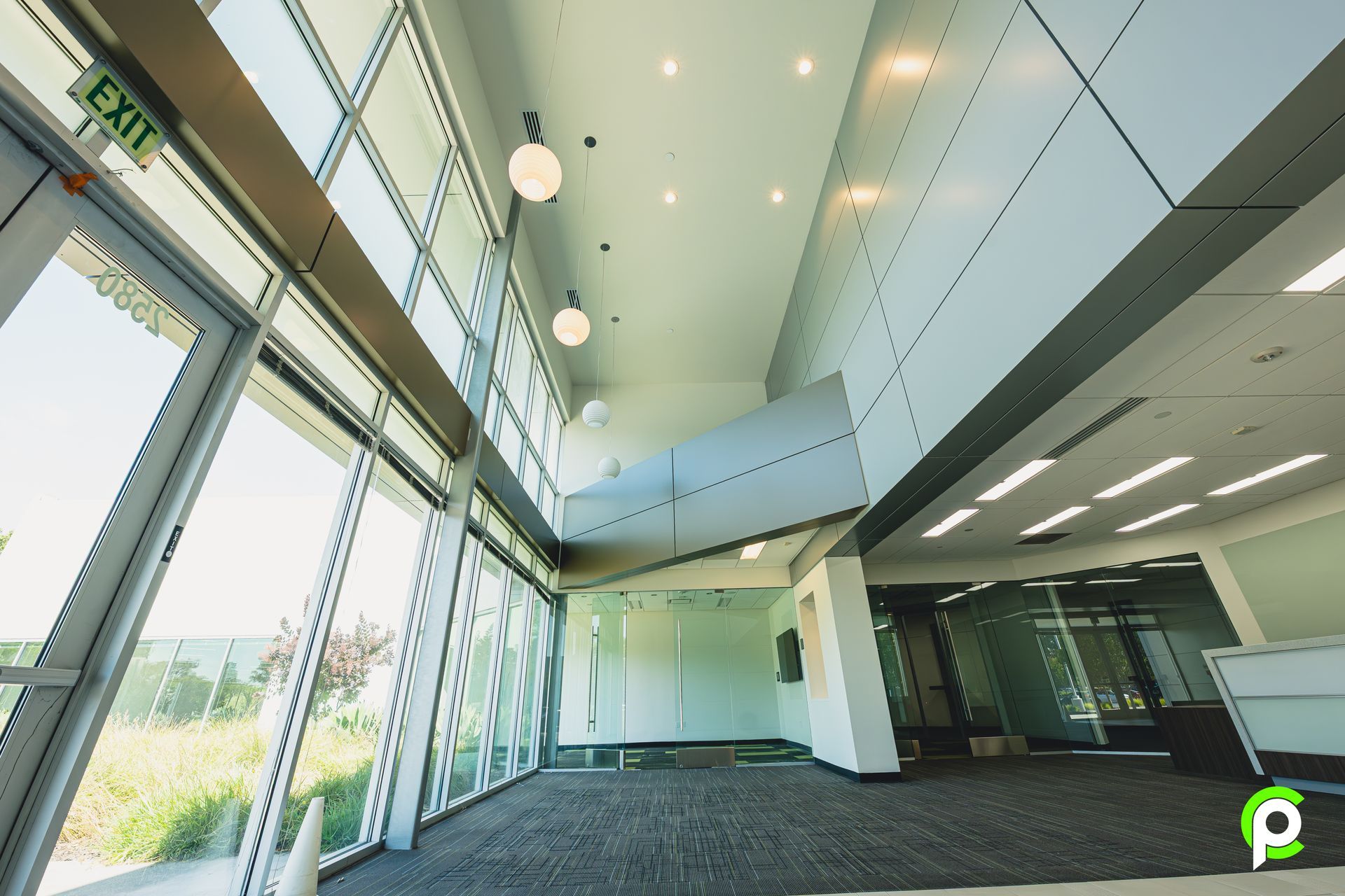 A large building with a green exit sign on the ceiling