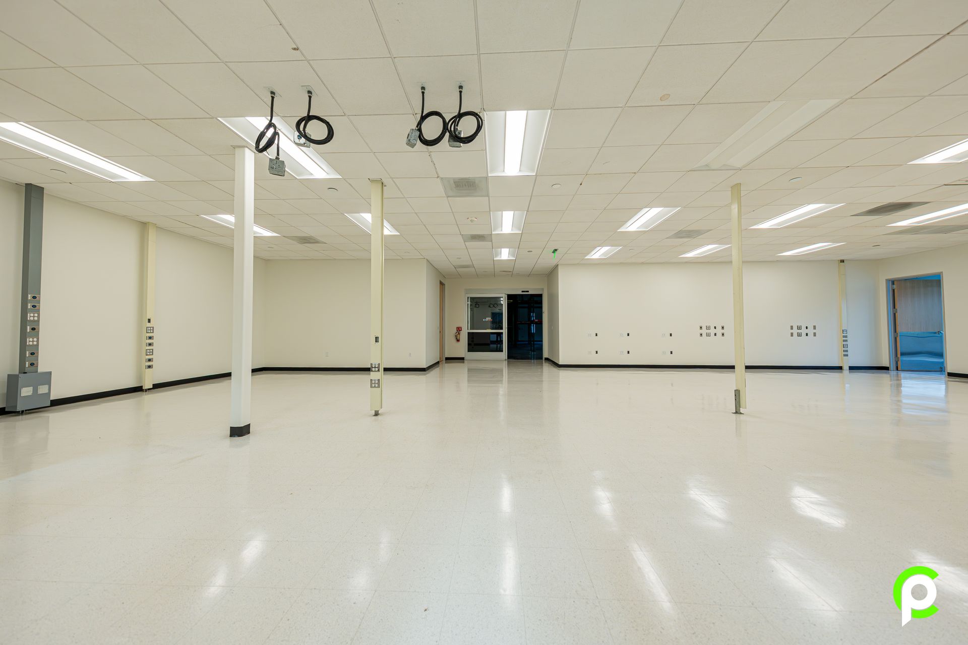 A large empty room with white walls and a white floor.