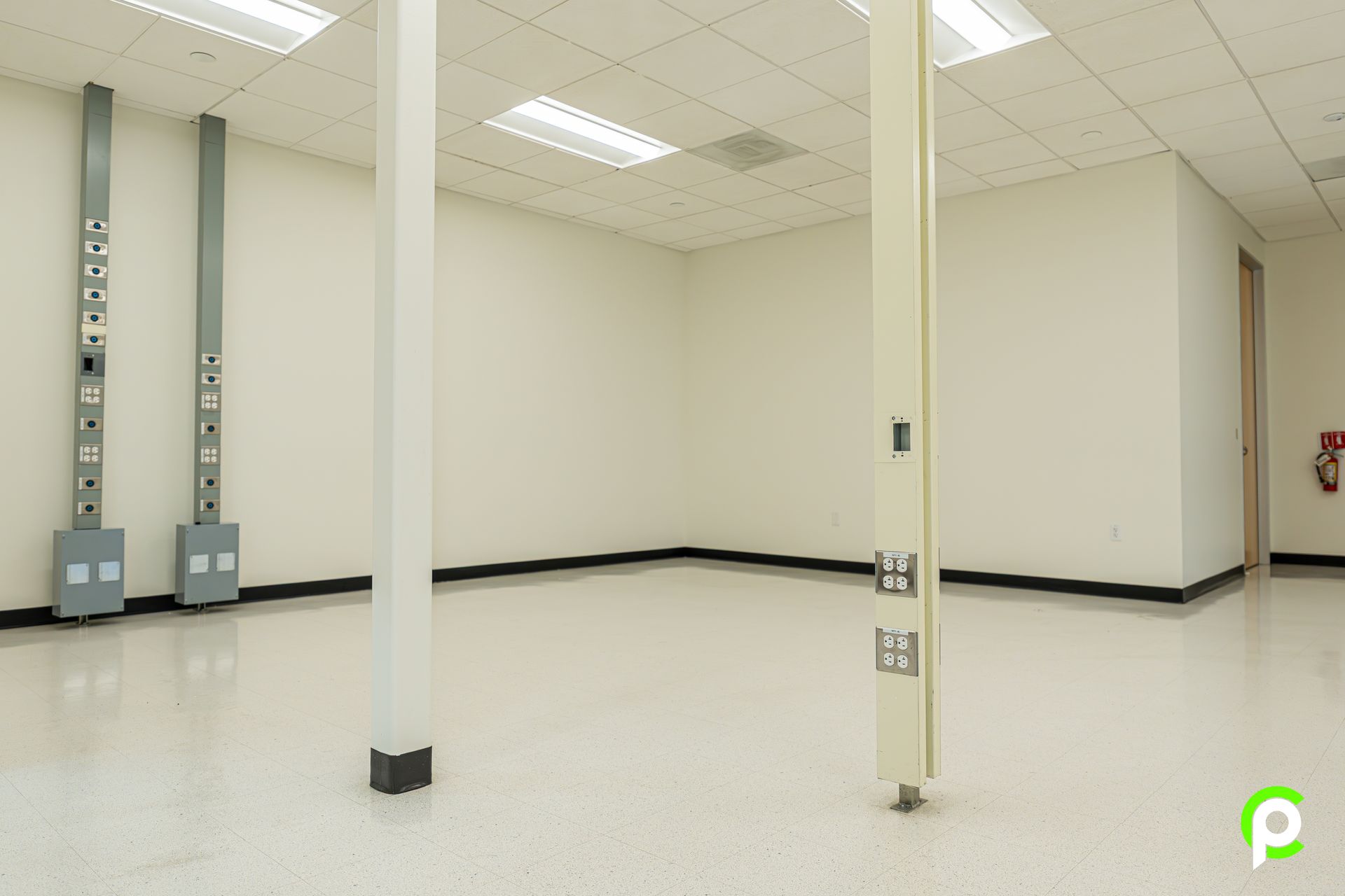 A large empty room with white walls and a white floor.