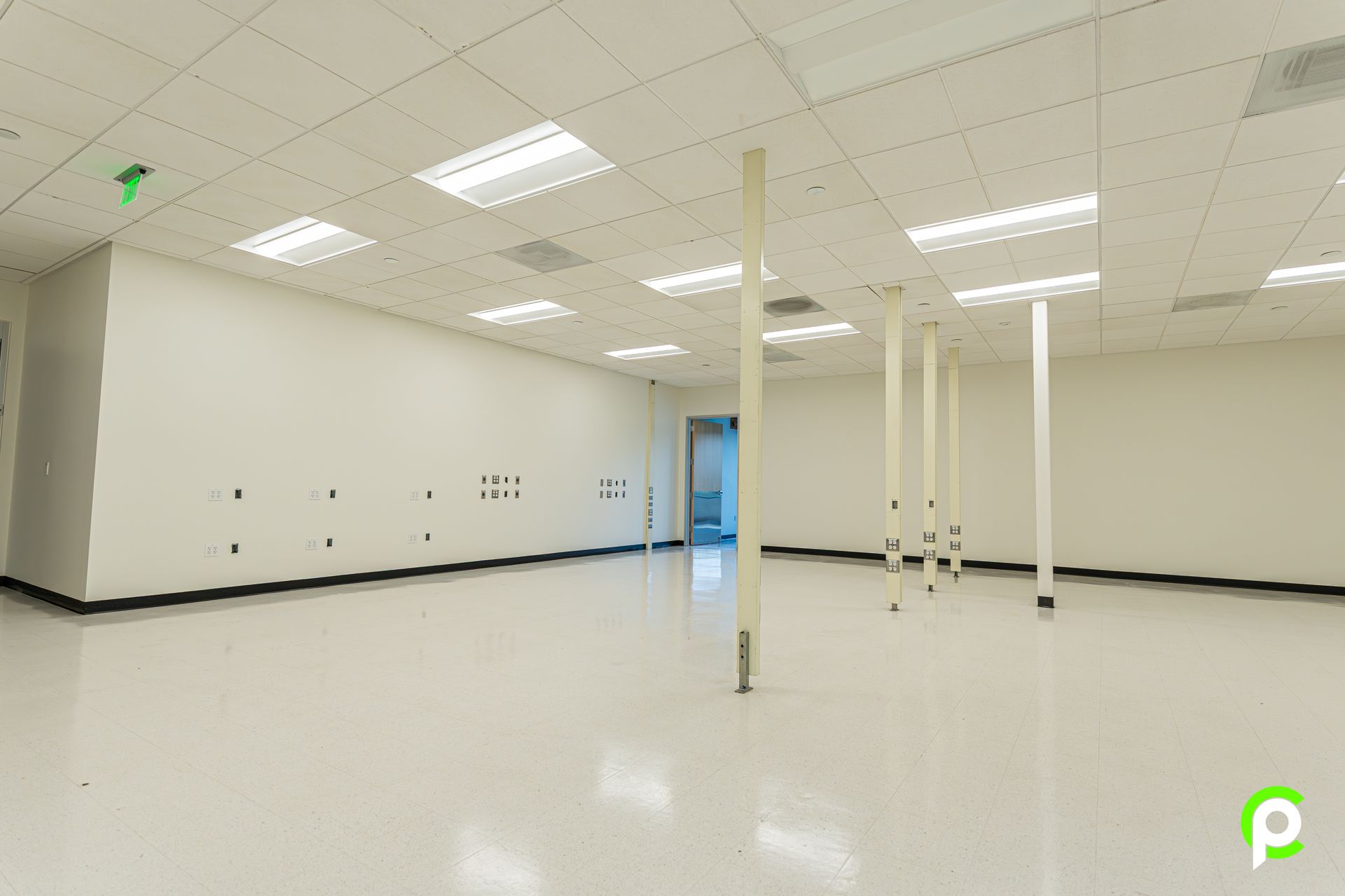 A large empty room with white walls and white floors