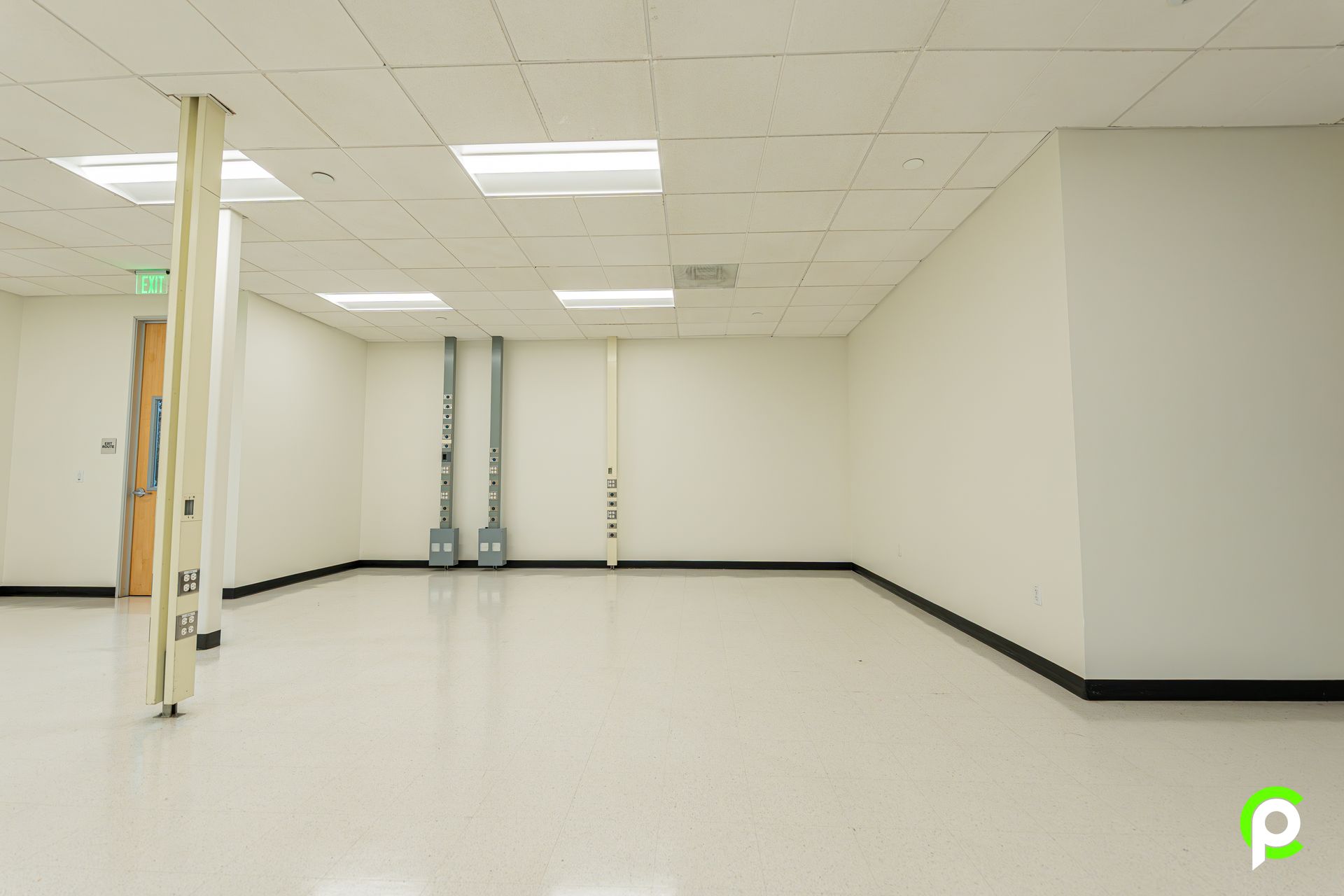 An empty room with white walls and a white floor