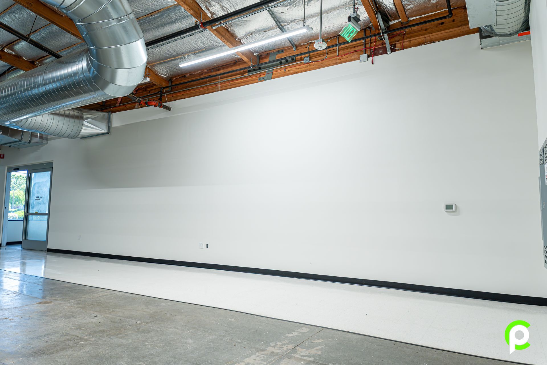 There is a large white wall in the middle of the room.