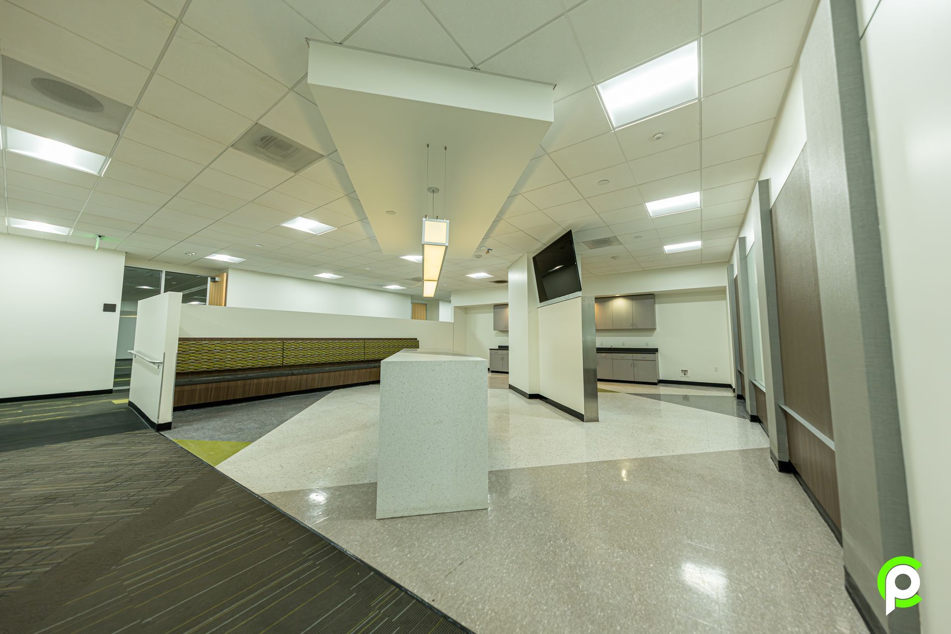 A large empty room with a table in the middle of it.