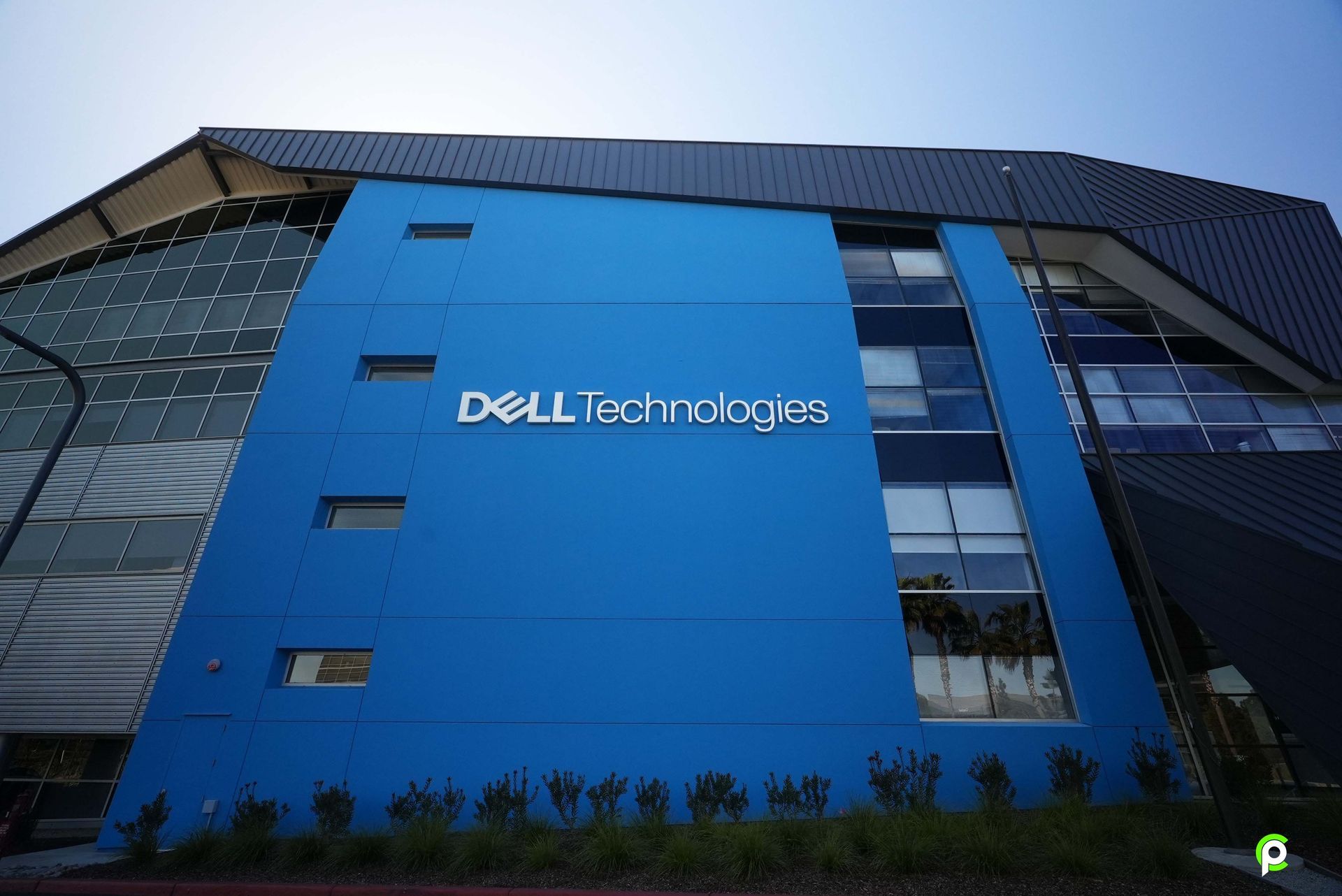 Blue exterior of a Dell Technologies building with the company logo. The building has a modern design with glass and dark panels.
