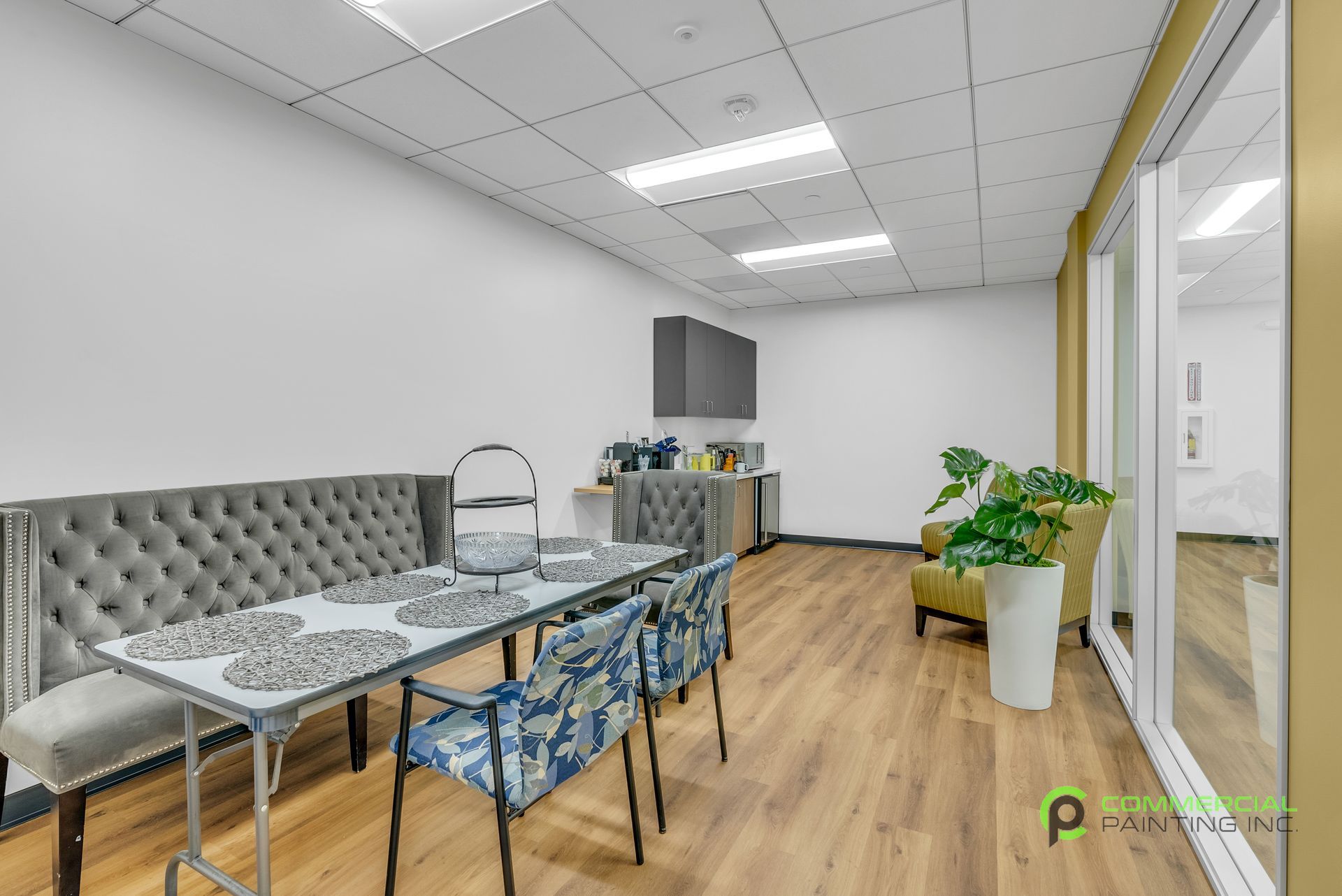 A large room with a table and chairs in it.