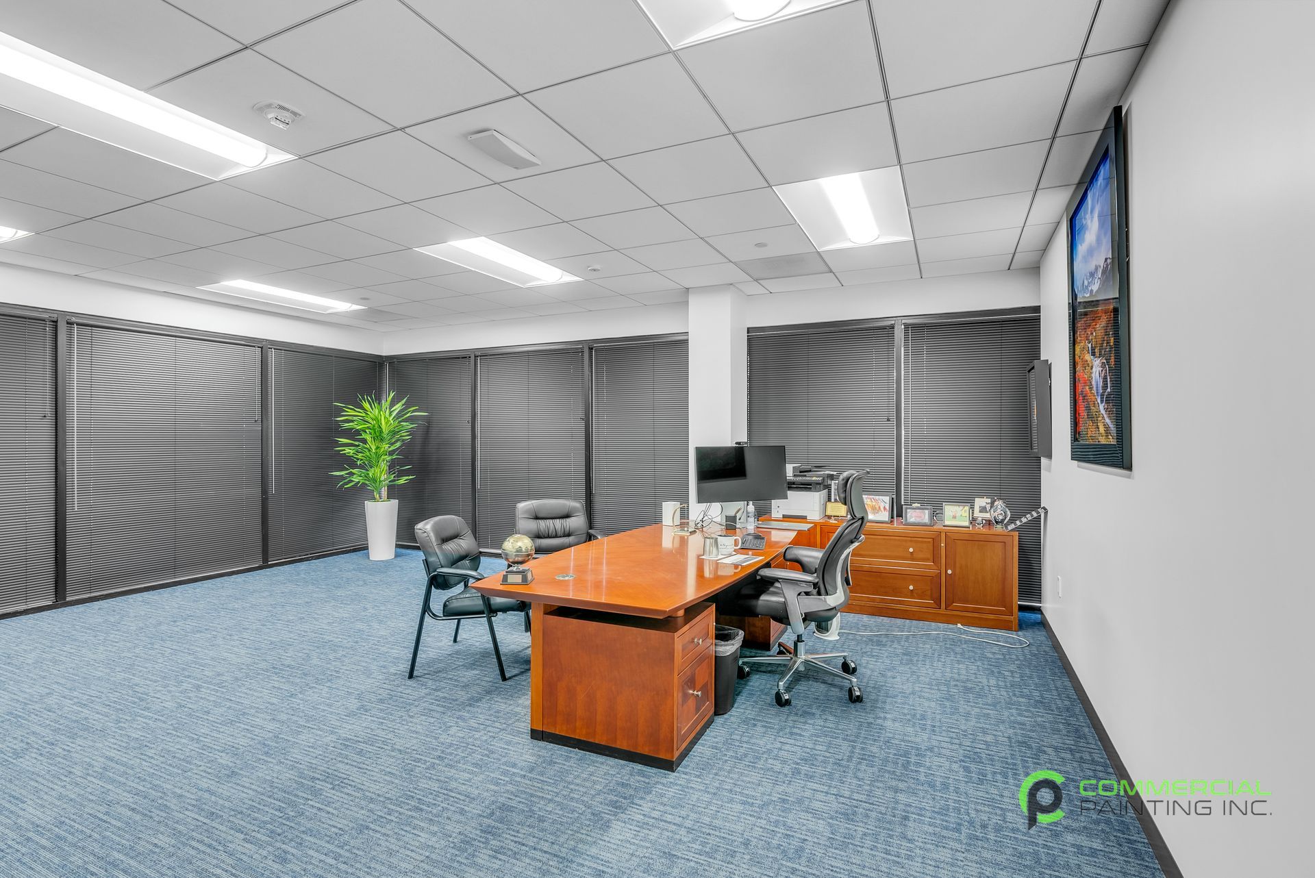 A large room with a table and chairs in it.