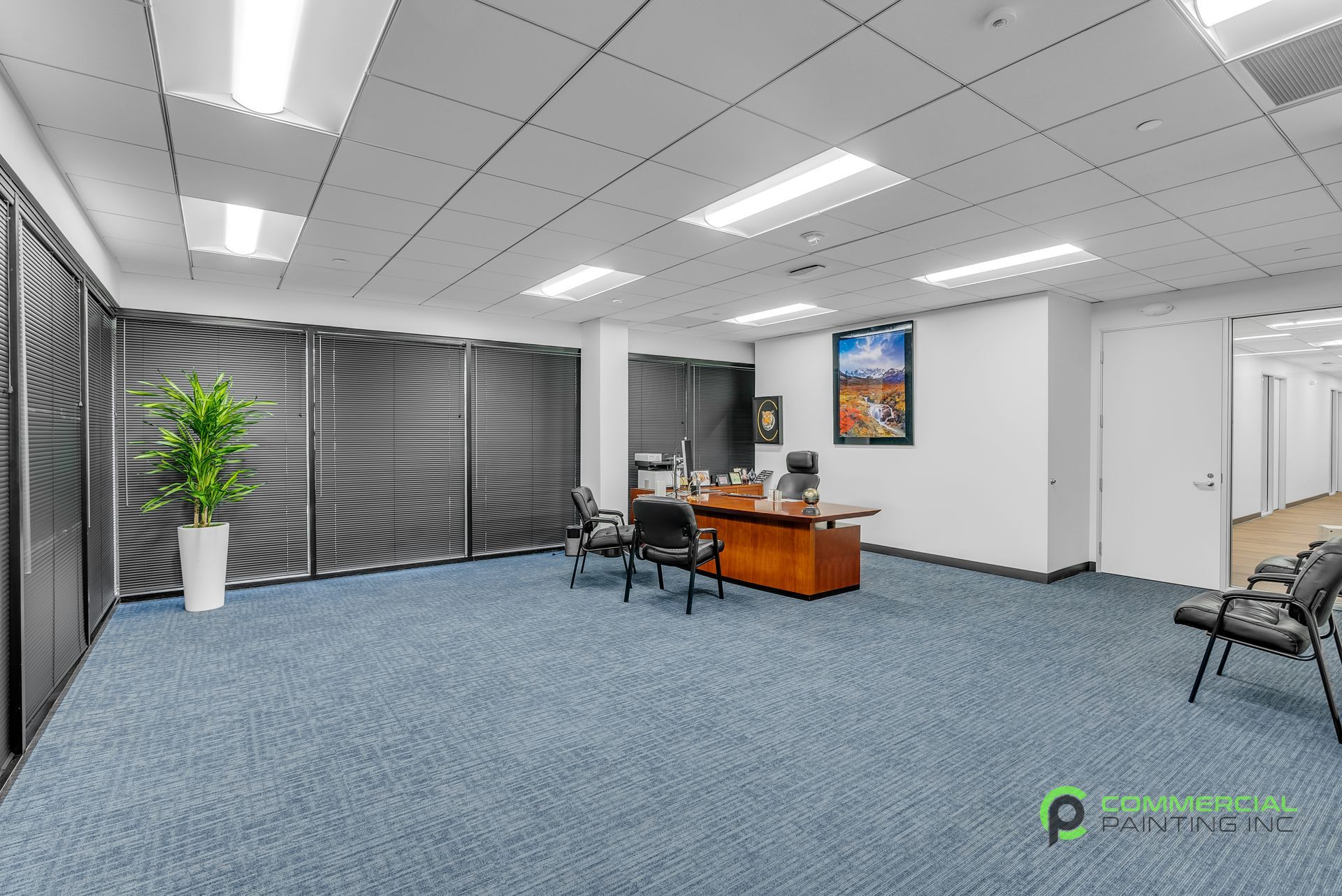 A large empty office with a desk and chairs.