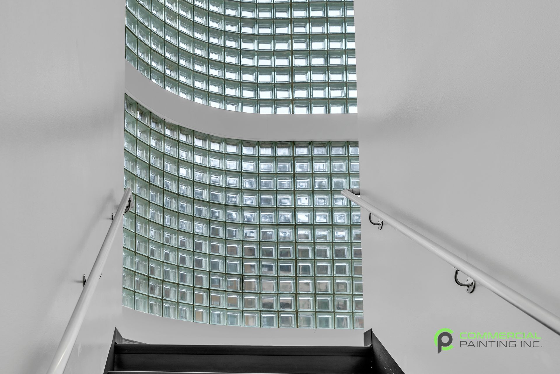 A picture of a staircase with a reflection of a building