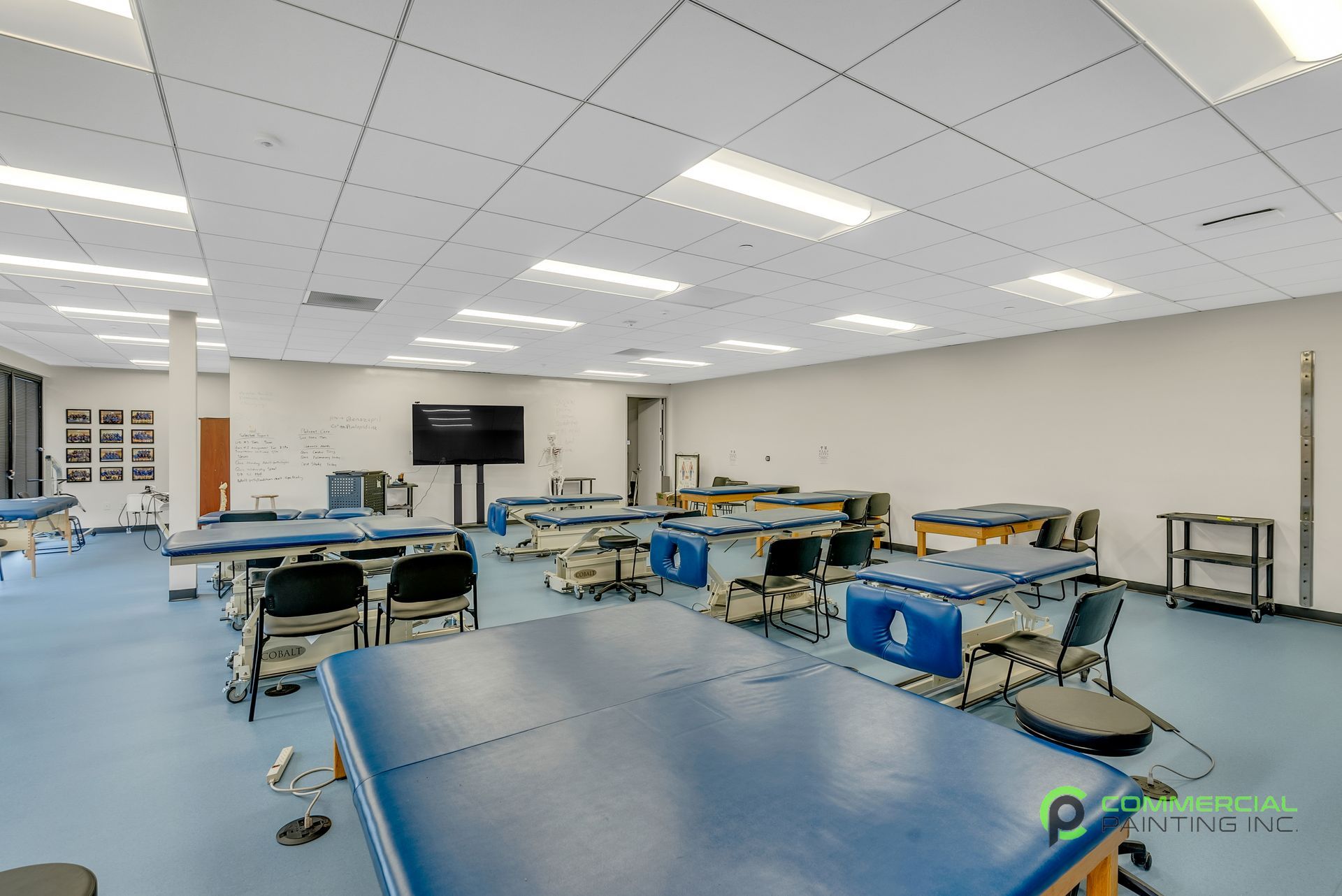 A large room with lots of blue tables and chairs