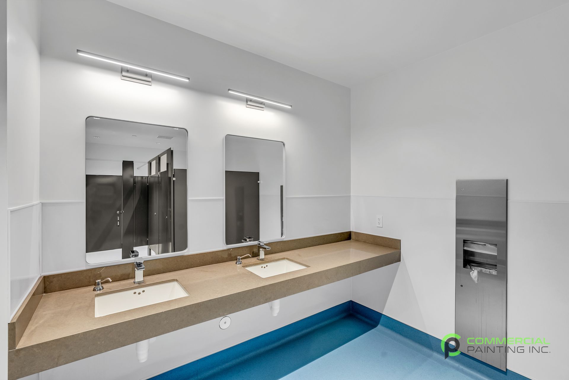 A public restroom with two sinks and two mirrors.