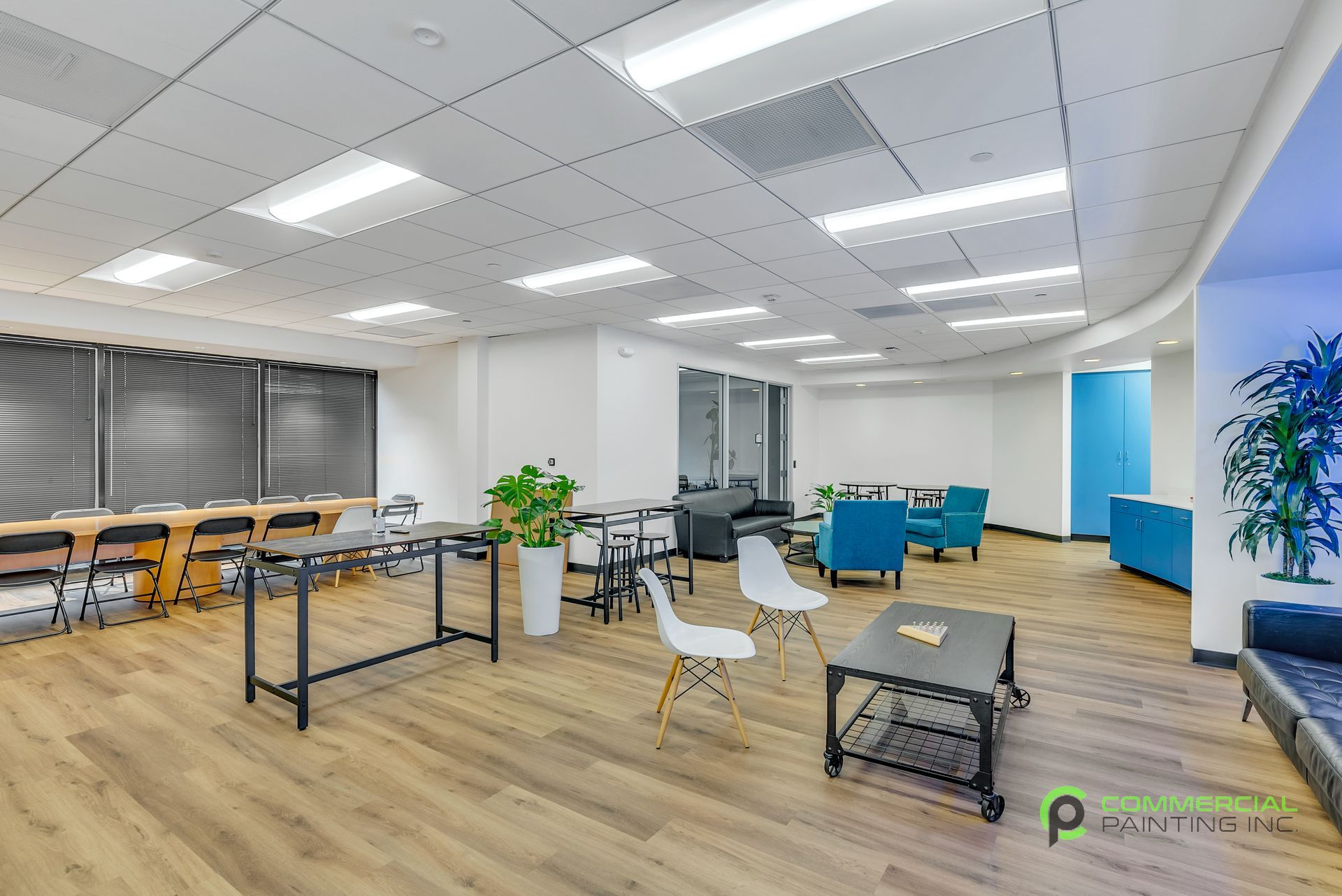A large room with wooden floors and tables and chairs.