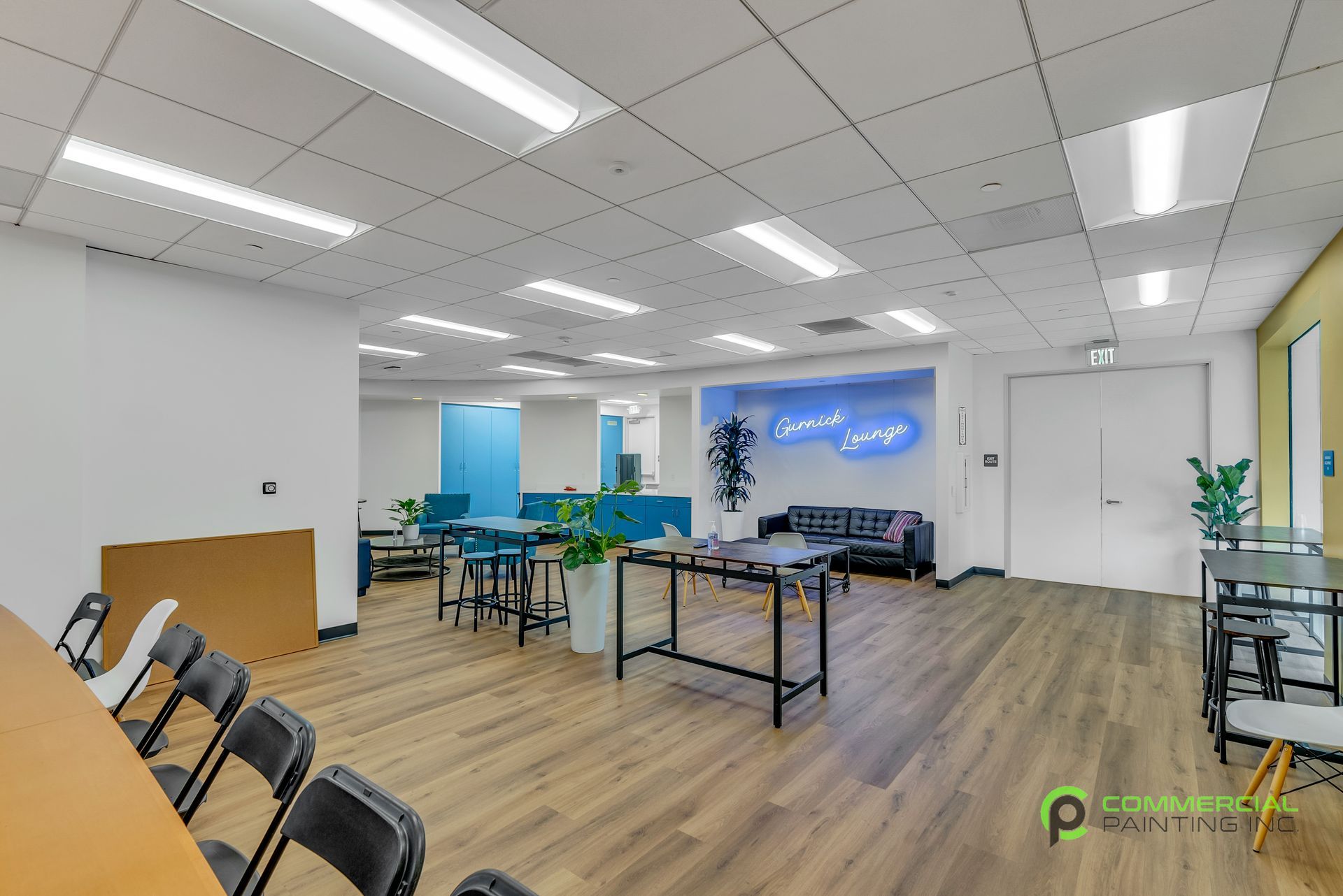 A large room with tables , chairs , and a couch.