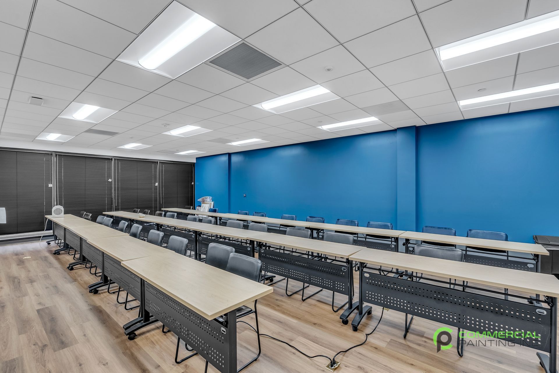 A large room with a lot of tables and chairs in it.