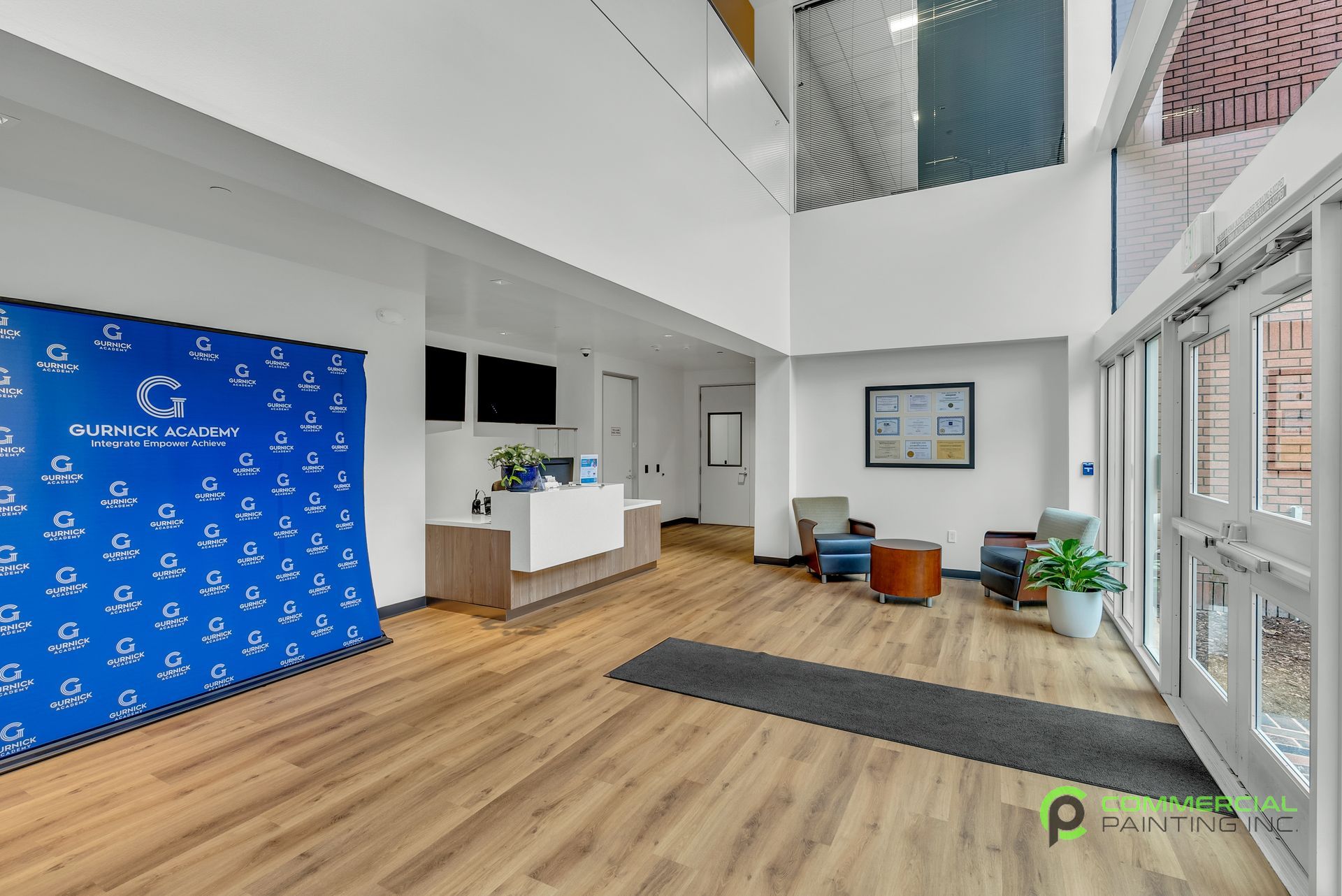 A large lobby with a blue wall and a reception desk.